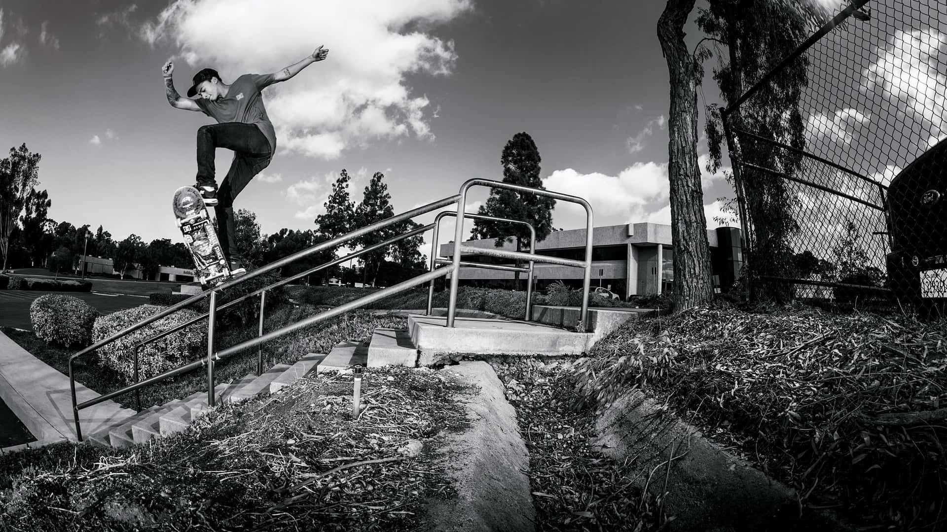 Skateboarder Grinding Down Rail Background