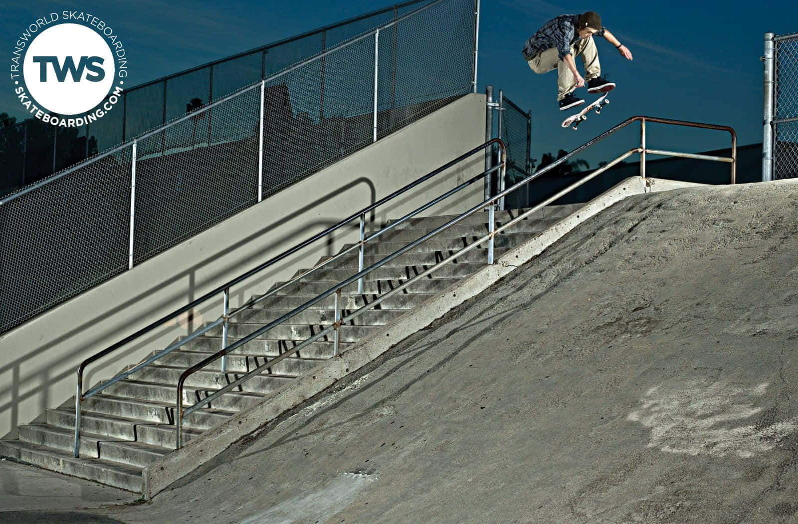 Skateboarder Midair Trick Over Stairs.jpg Background