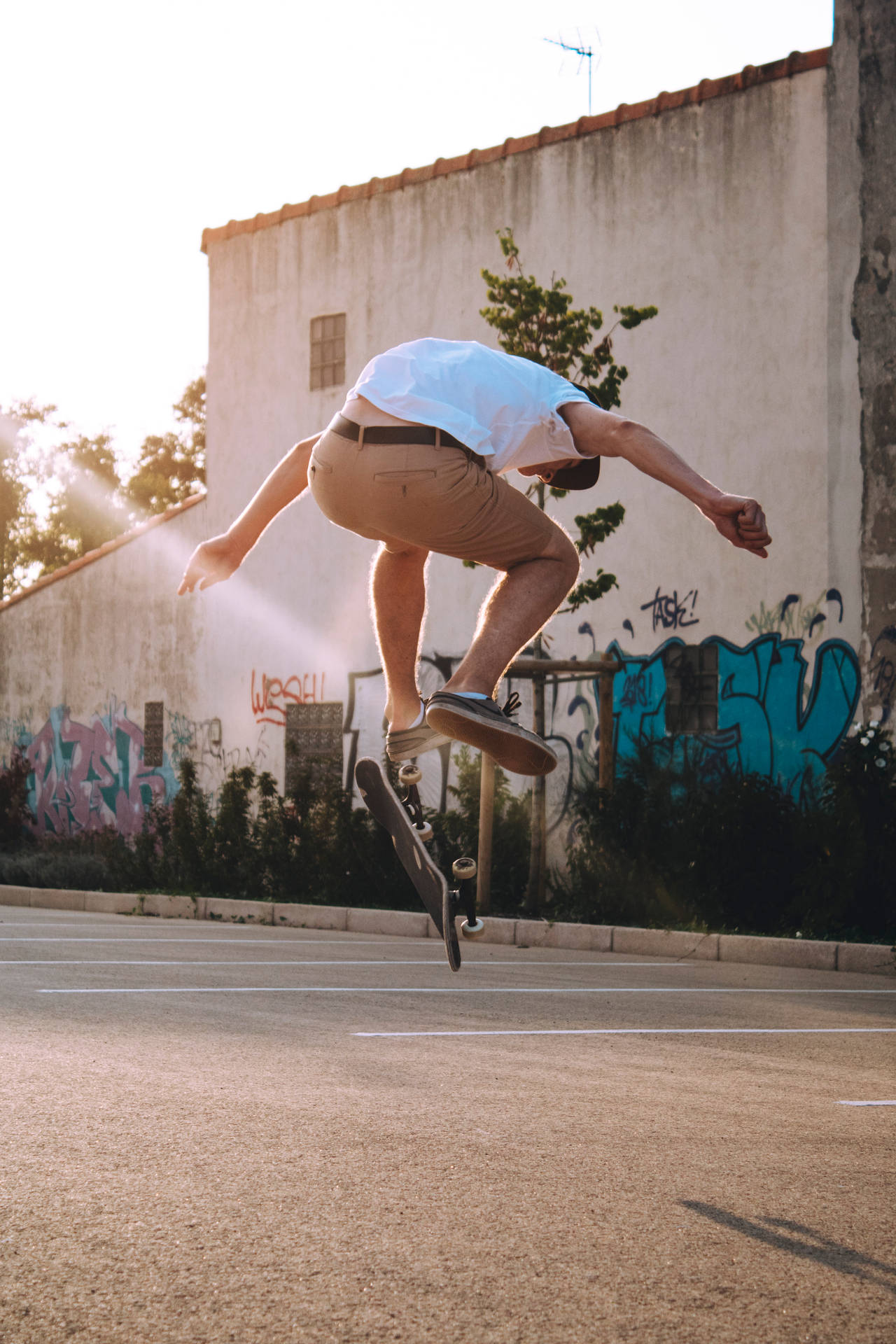 Skateboarder Performing A Stubborn Flip Background