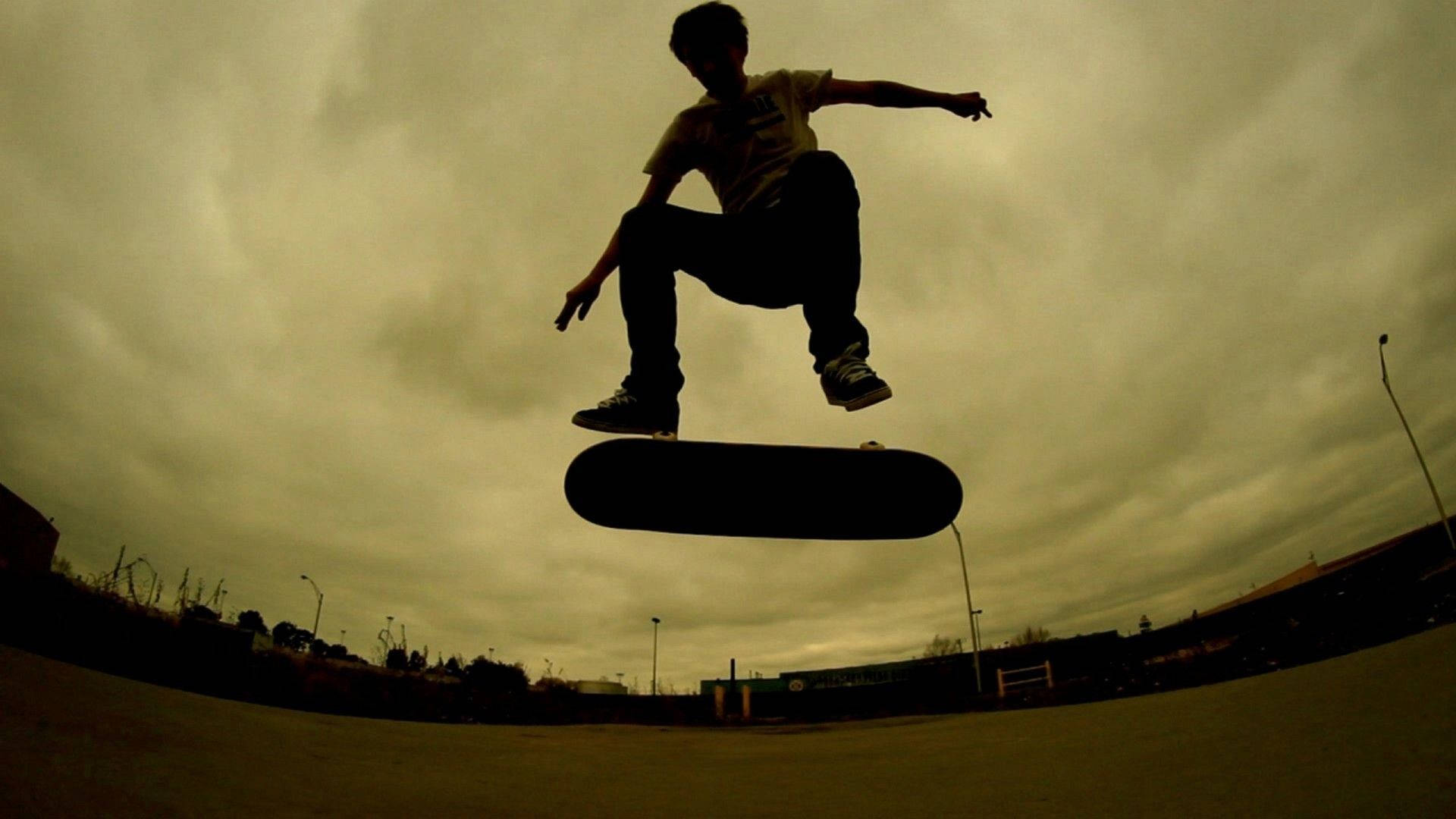 Skateboarder Takes A Big Jump Background