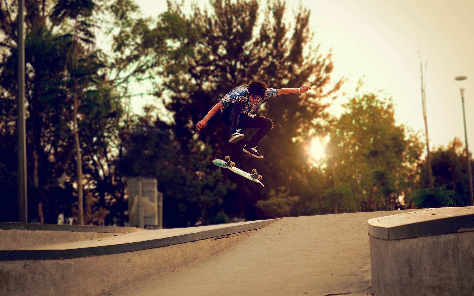 Skater Boy Nollie Trick At Sunset Background