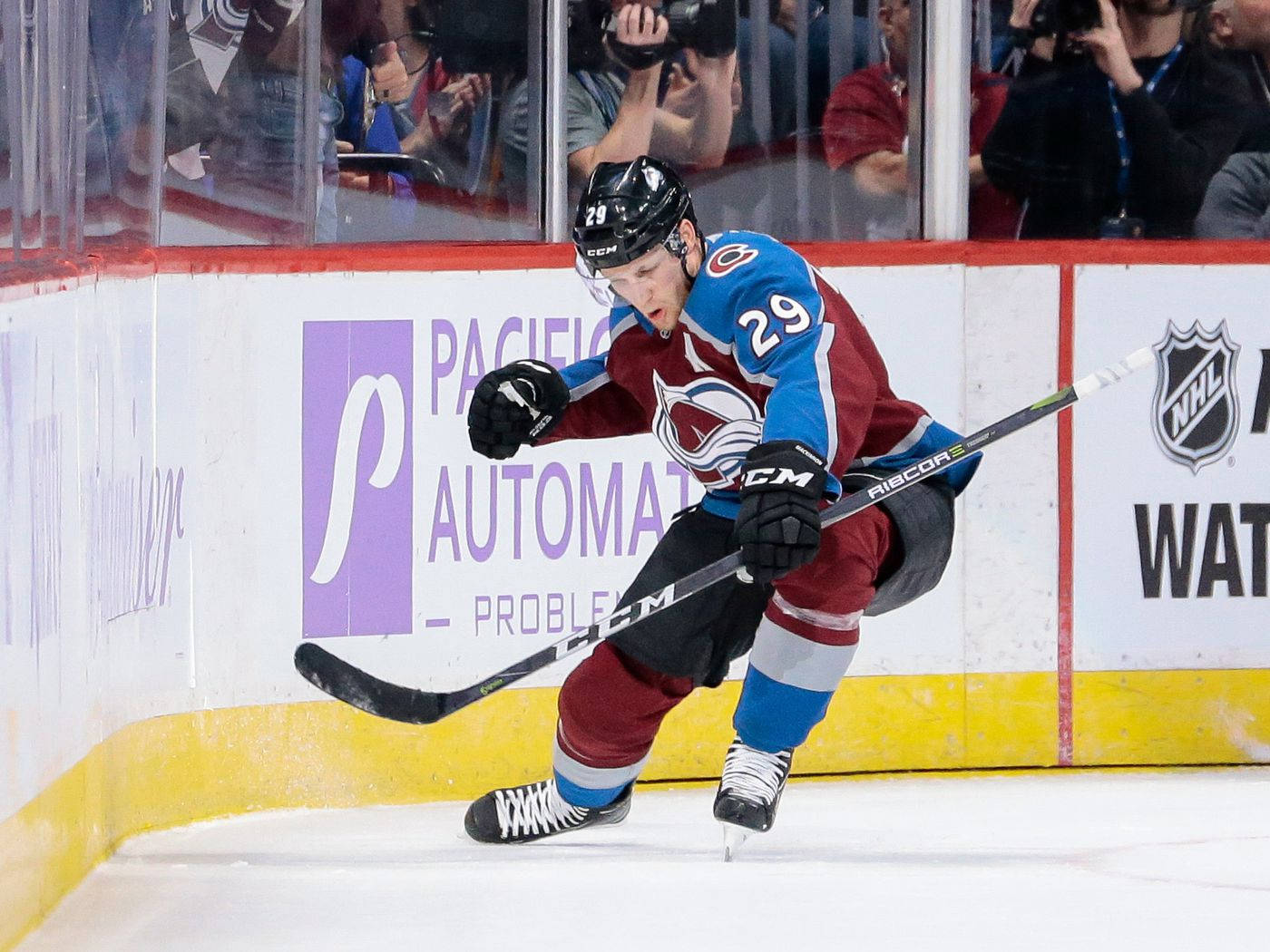 Skating Ice Hockey Player Nathan Mackinnon Background