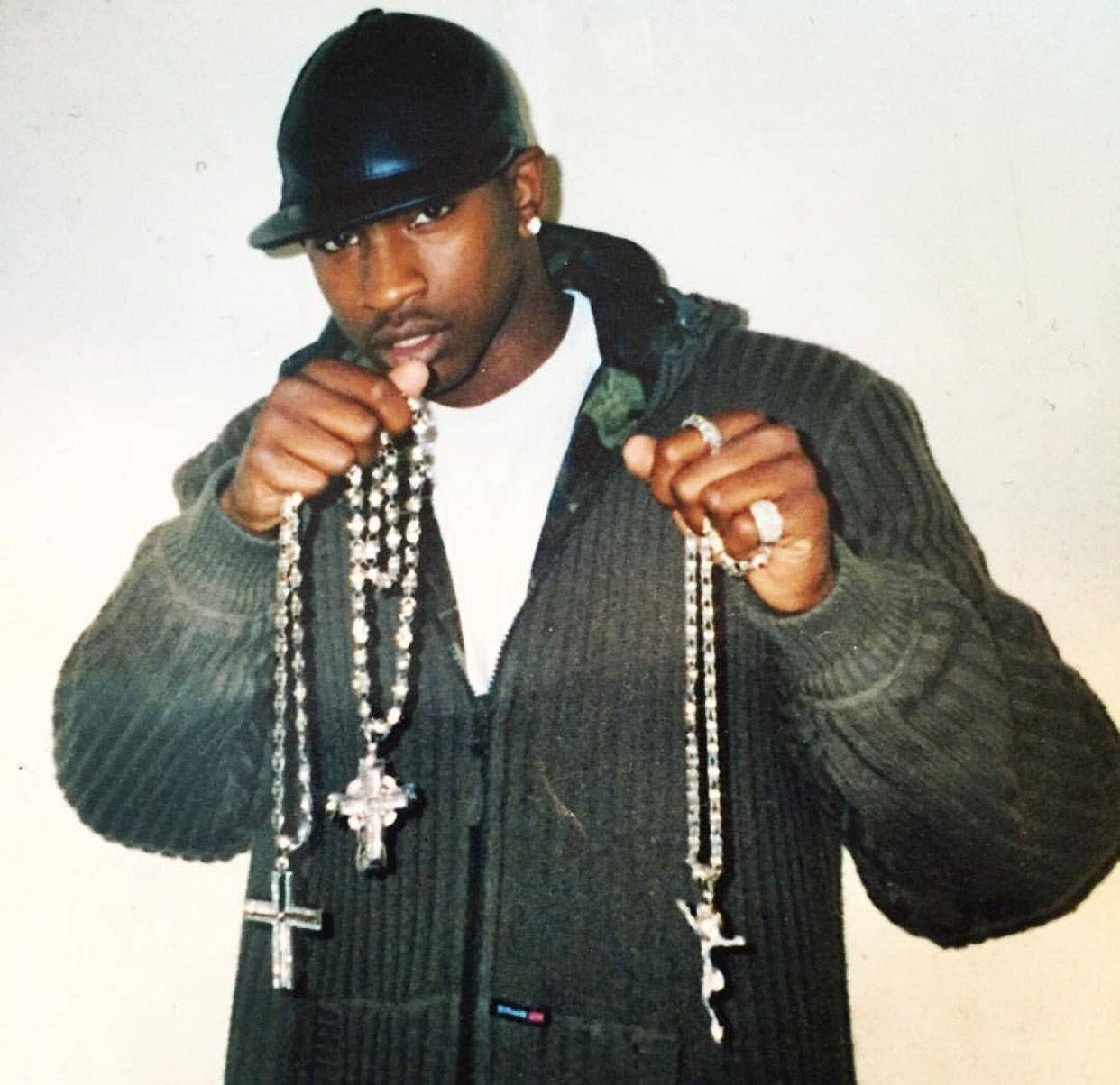 Skepta Holding Multiple Rosaries Background