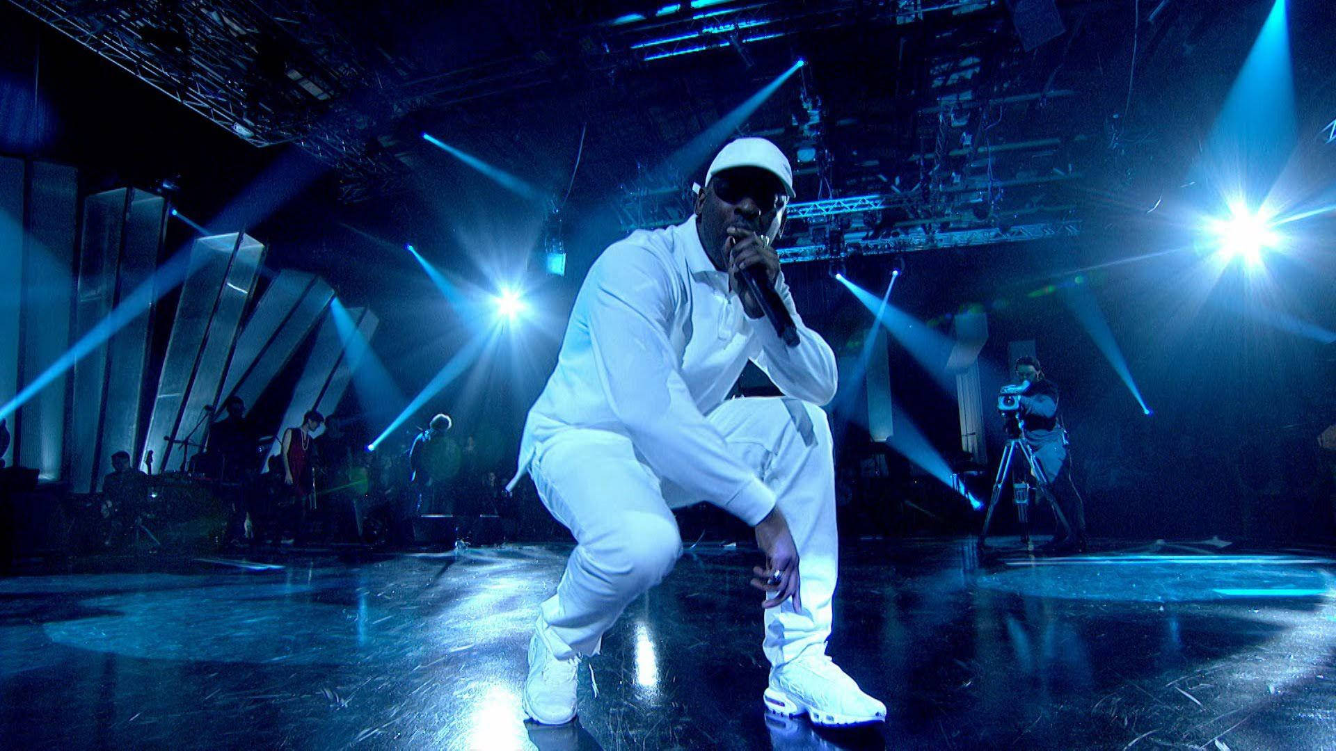 Skepta Performing On Stage Background