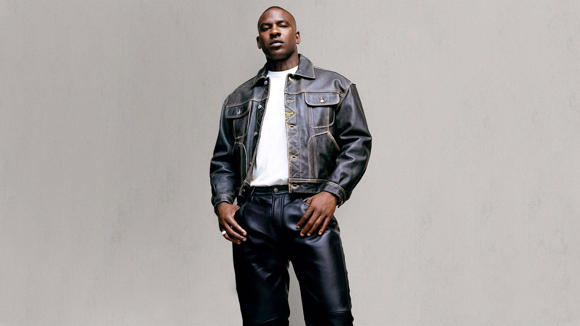 Skepta's Black Leather Outfit Background