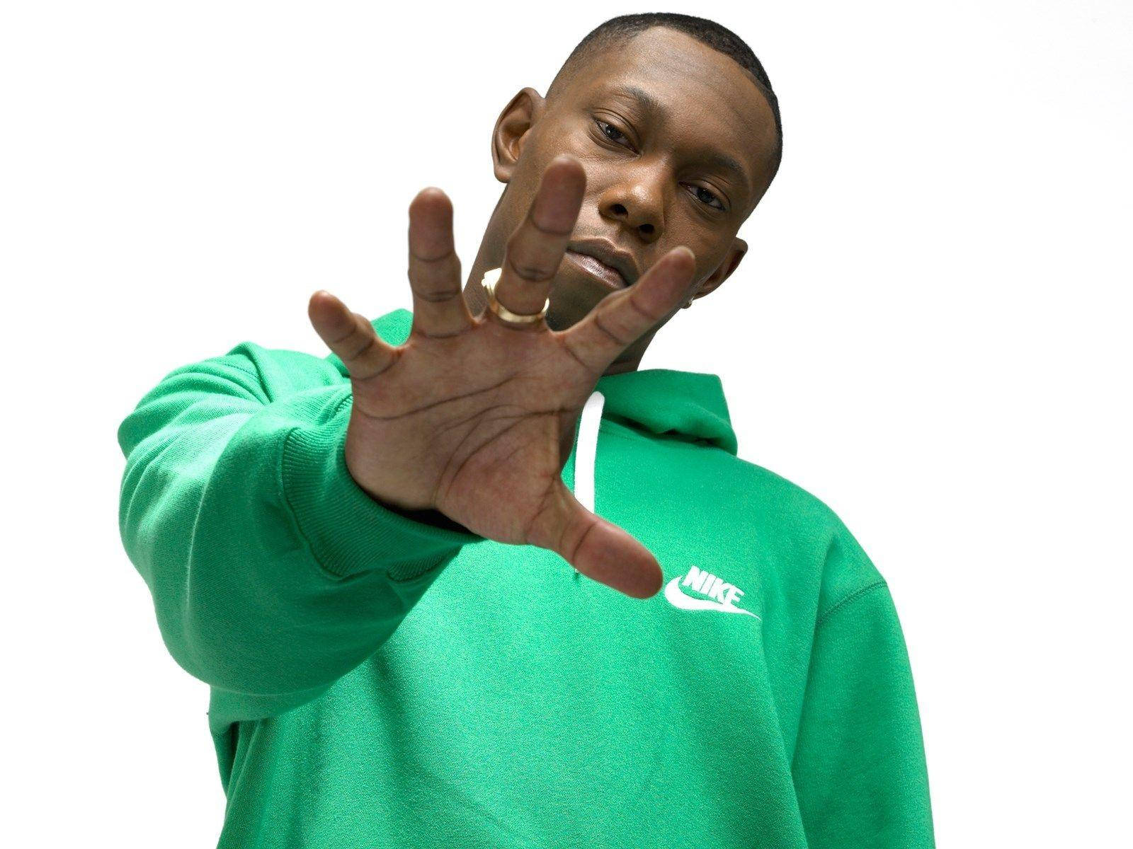 Skepta With His Hand Open Background