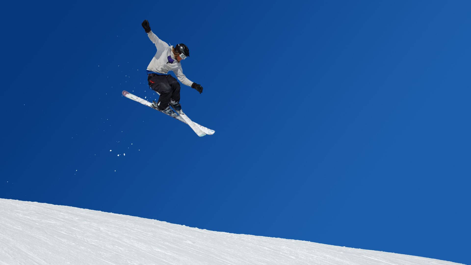 Ski Jumper Mid-air In A Majestic Winter Environment Background