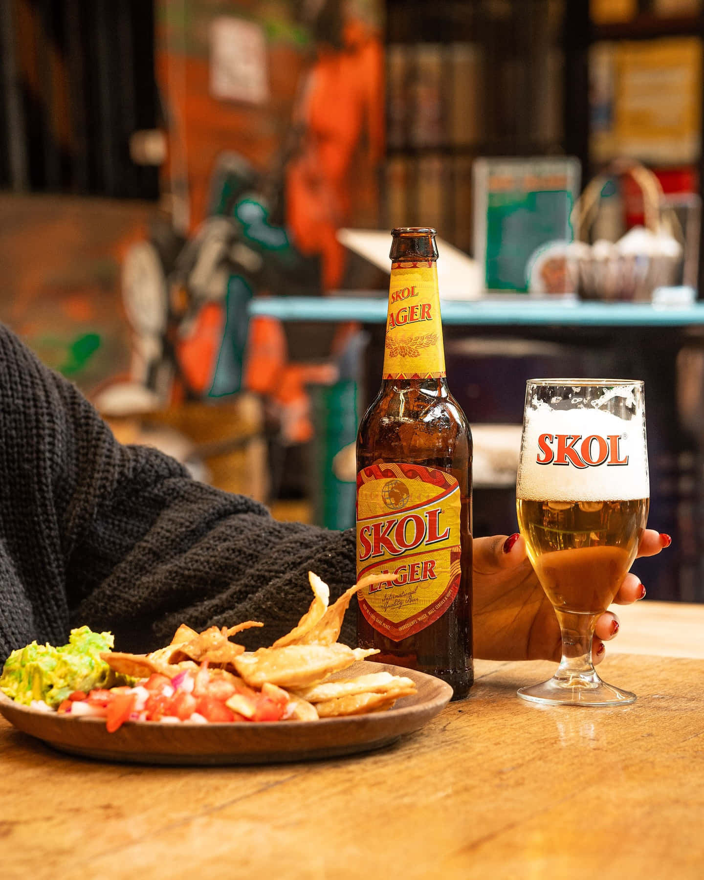 Skol Beer Bottleand Glasswith Food Background