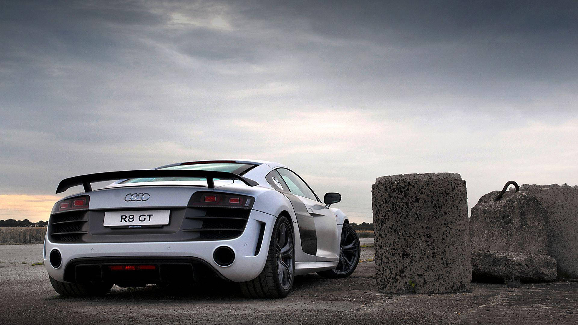 Sleek Audi R8 Coupe In Dynamic Pose Background