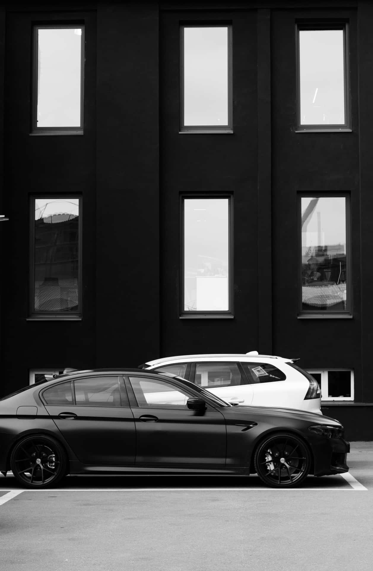 Sleek_ Black_ Car_ Against_ Modern_ Building