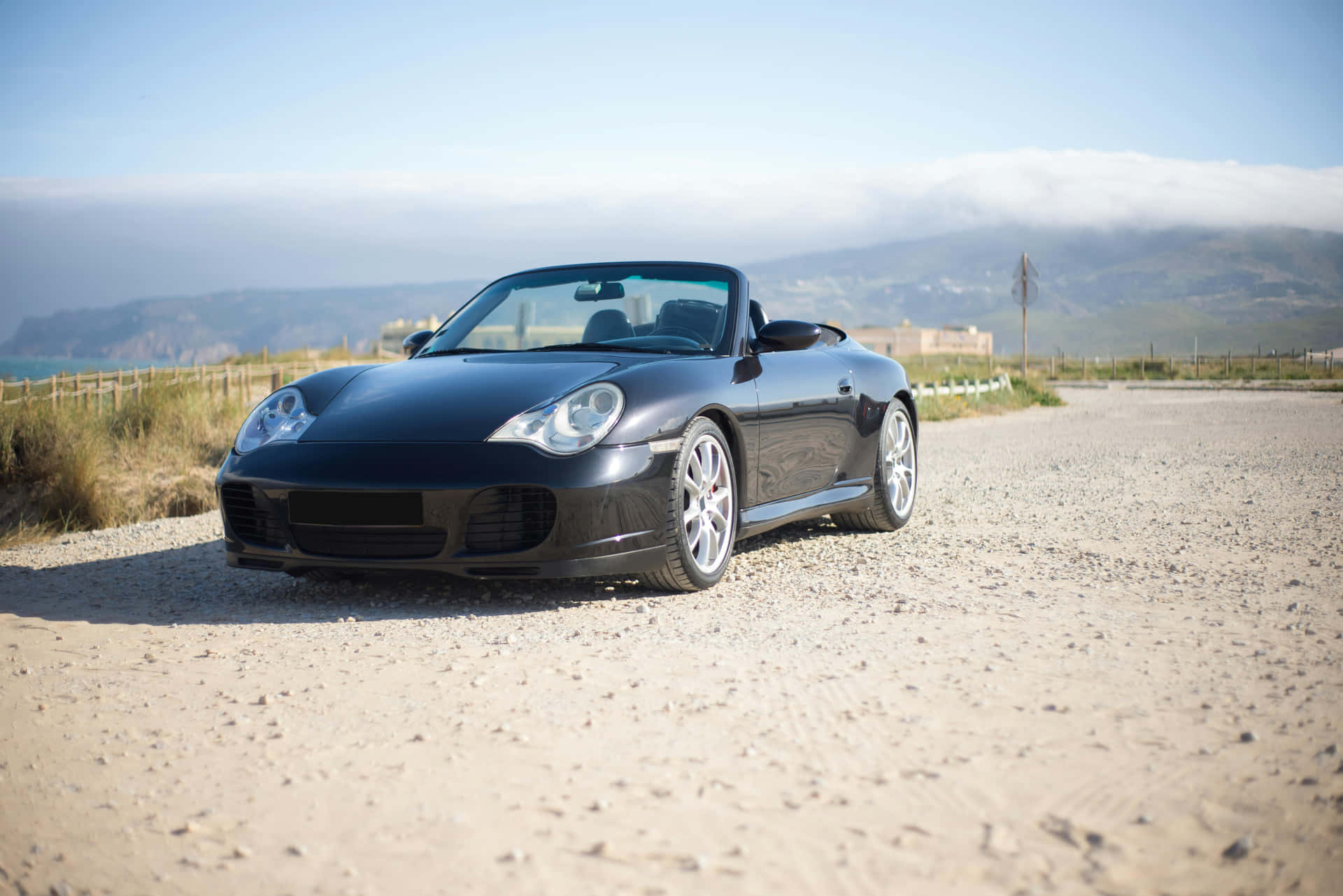 Sleek_ Black_ Convertible_ Coastal_ Road.jpg Background