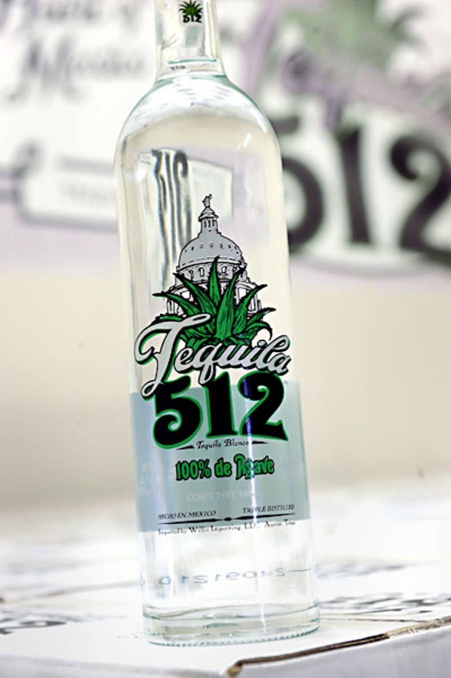 Sleek Bottle Of Tequila 512 On A Rustic Background. Background