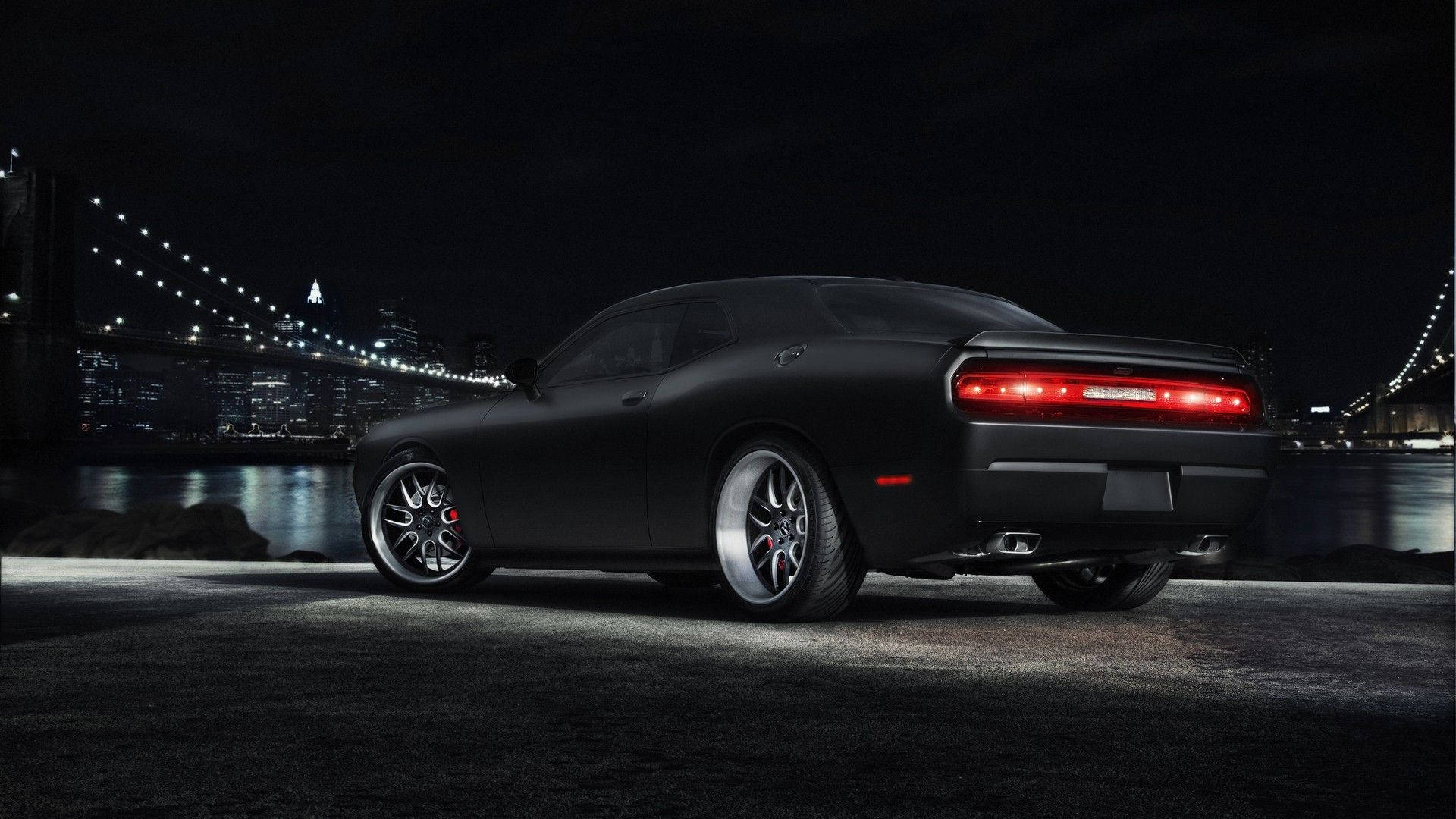 Sleek Dodge Challenger In Pitch Black Background