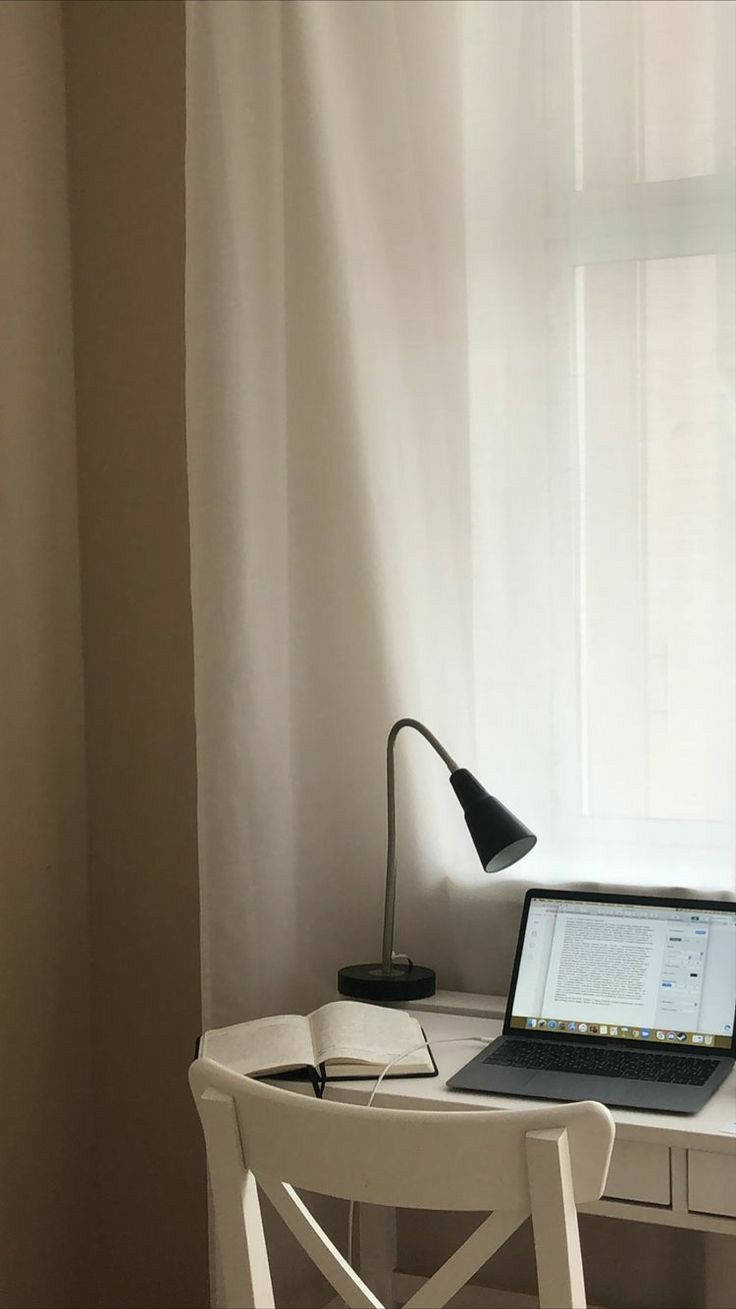 Sleek Iphone Desk Setup With Chic White Chair