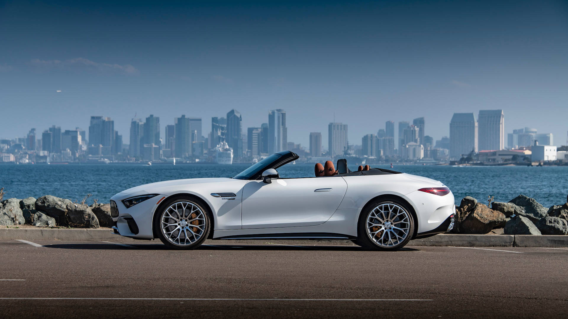 Sleek Mercedes Benz Cruising In The Urban Landscape Background