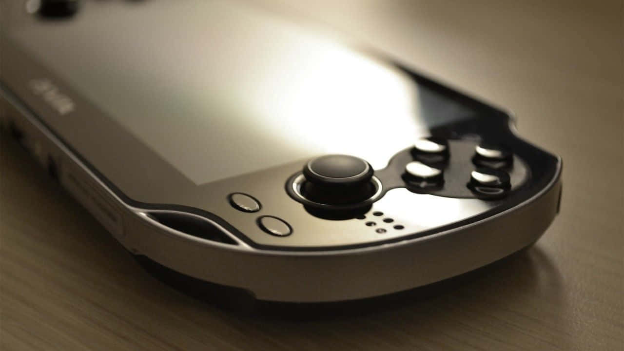 Sleek Playstation Vita On Gradient Background Background