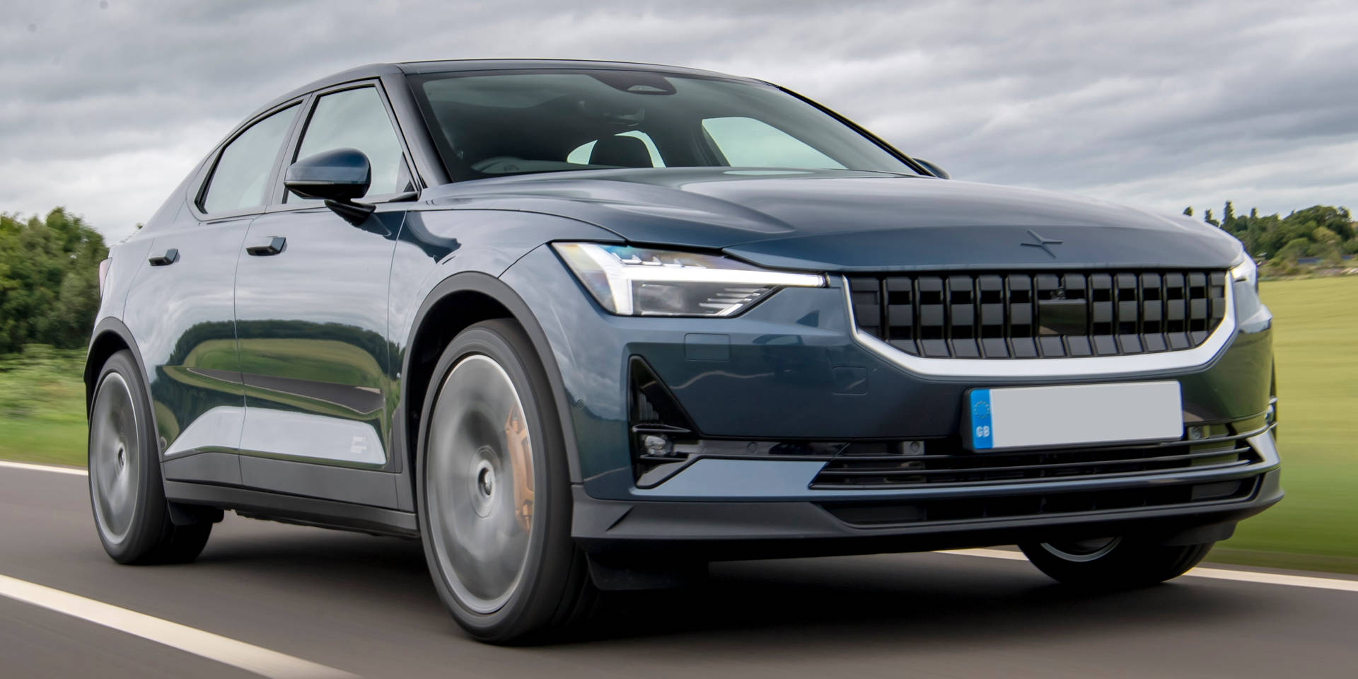 Sleek Polestar 2 Electric Vehicle Showcasing On A Bright Day Background