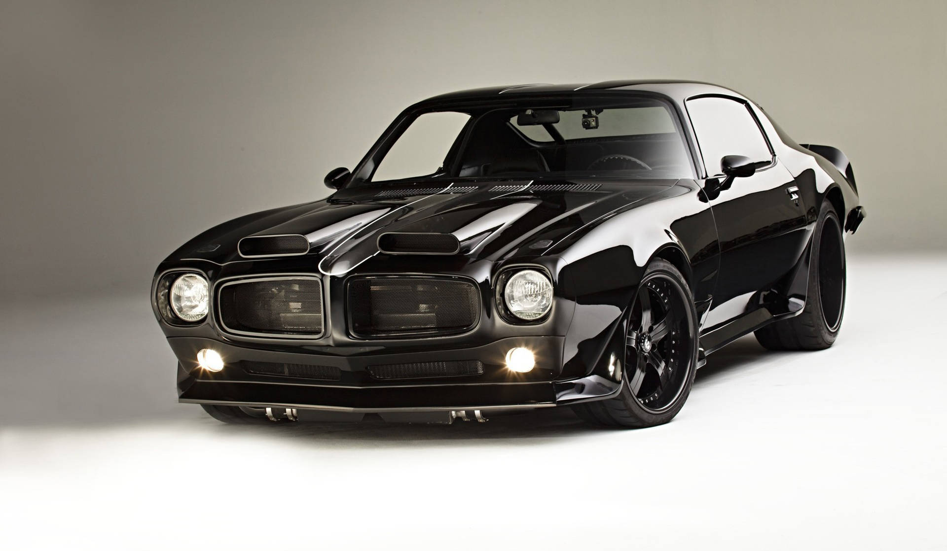 Sleek Pontiac Firebird - A Symbol Of Power In Black Background