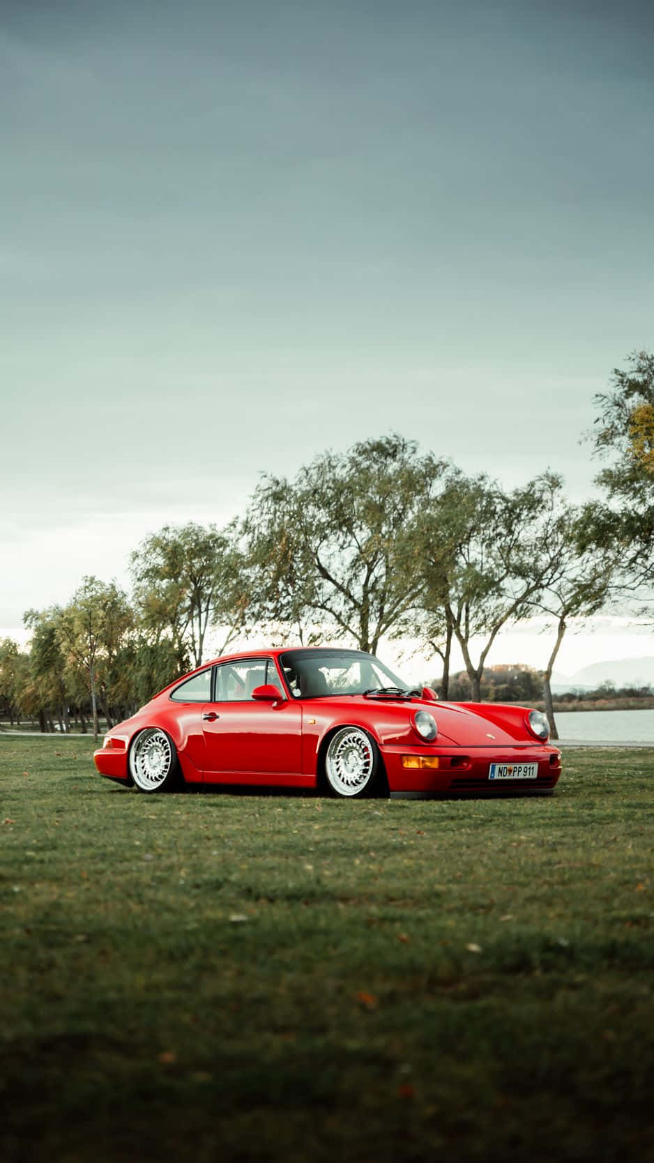 Sleek Porsche And Iphone Fusion Wallpaper Background