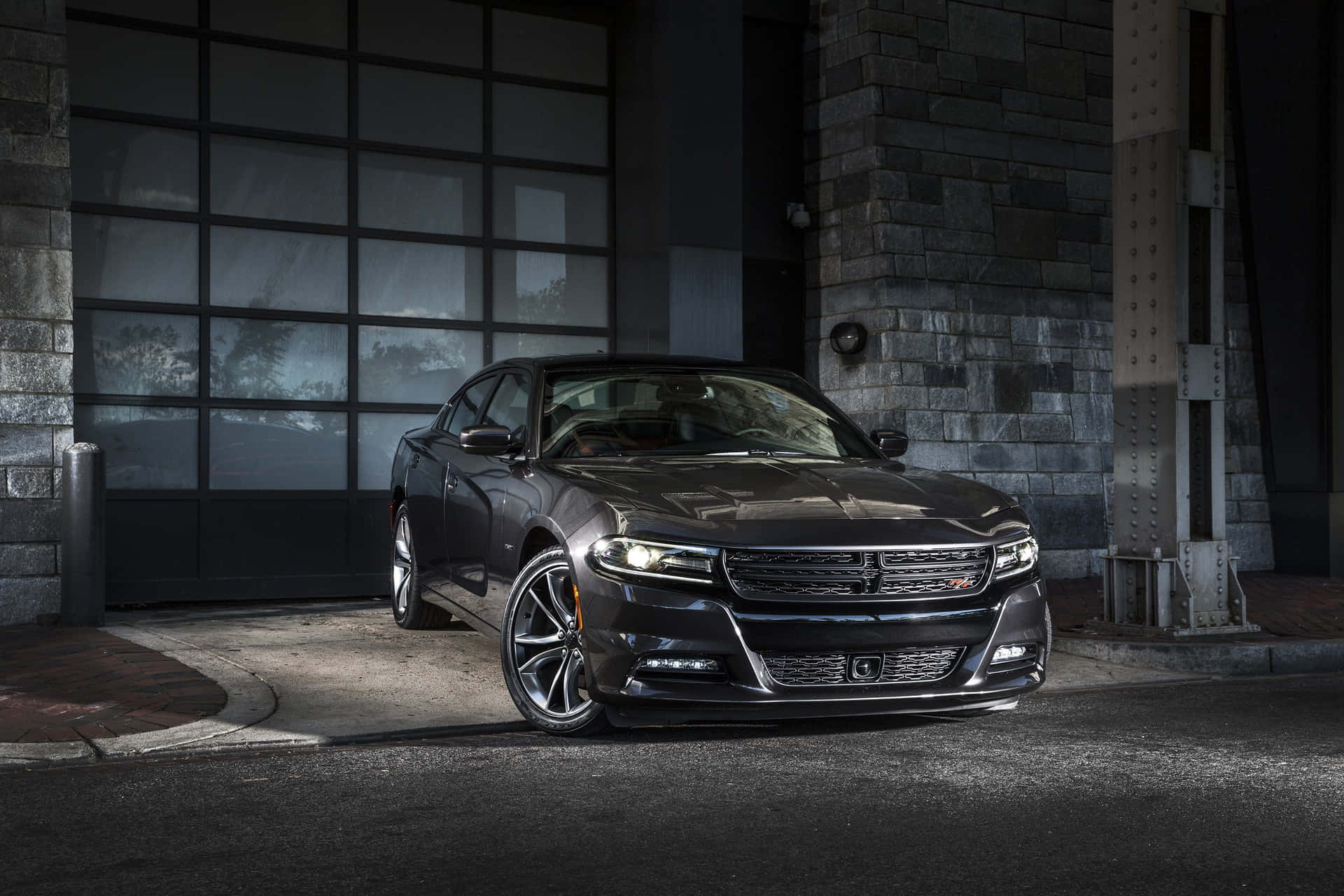 Sleek Red Dodge Charger On The Road Background