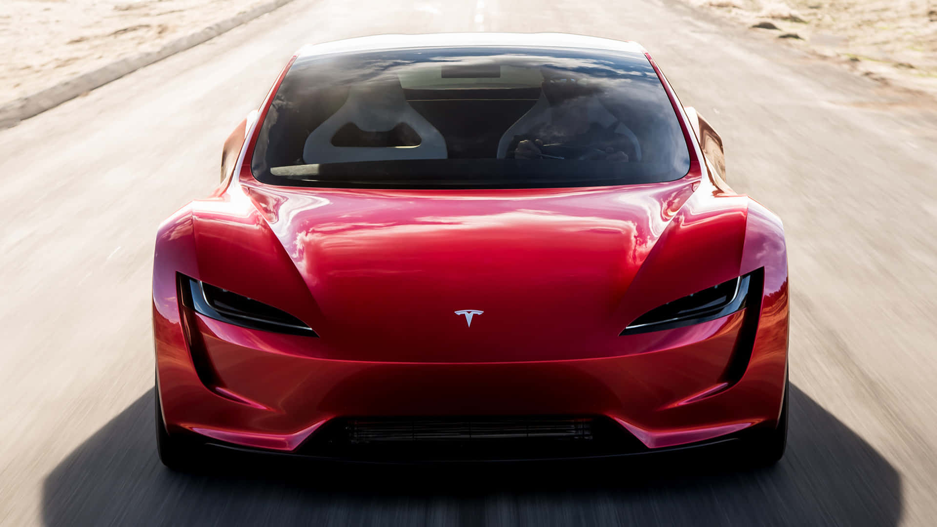Sleek Tesla Roadster Under Electric Blue Sky Background