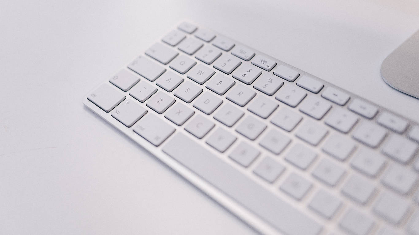 Sleek White Wireless Mac Keyboard Background