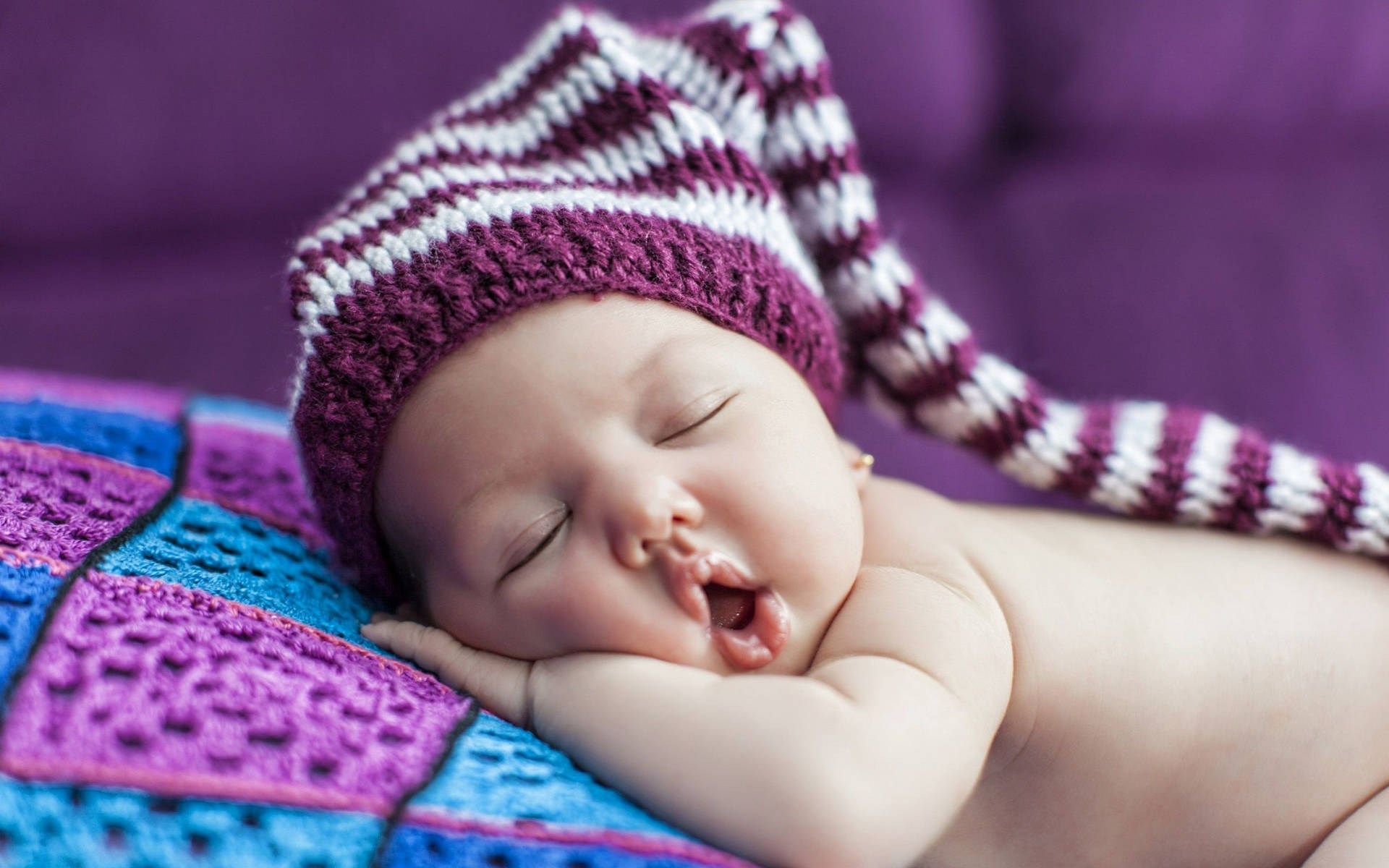 Sleeping Baby Wearing Purple Crochet Bonnet Background