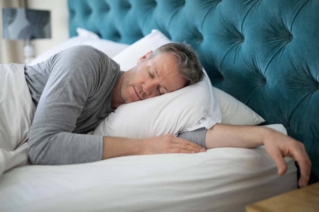 Sleeping Man In White Bed Background