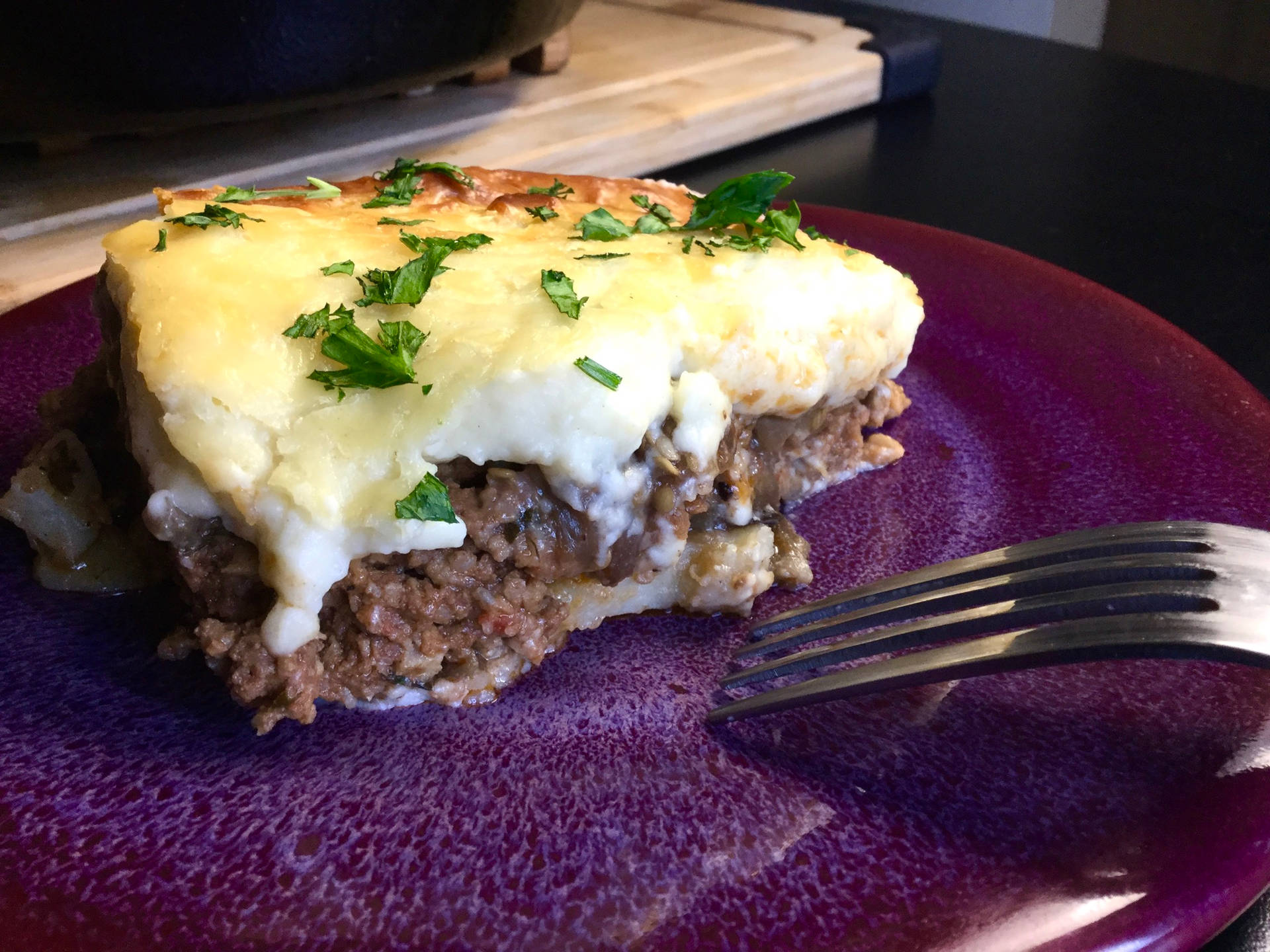 Slice Of Savory Moussaka On A Purple Plate Background