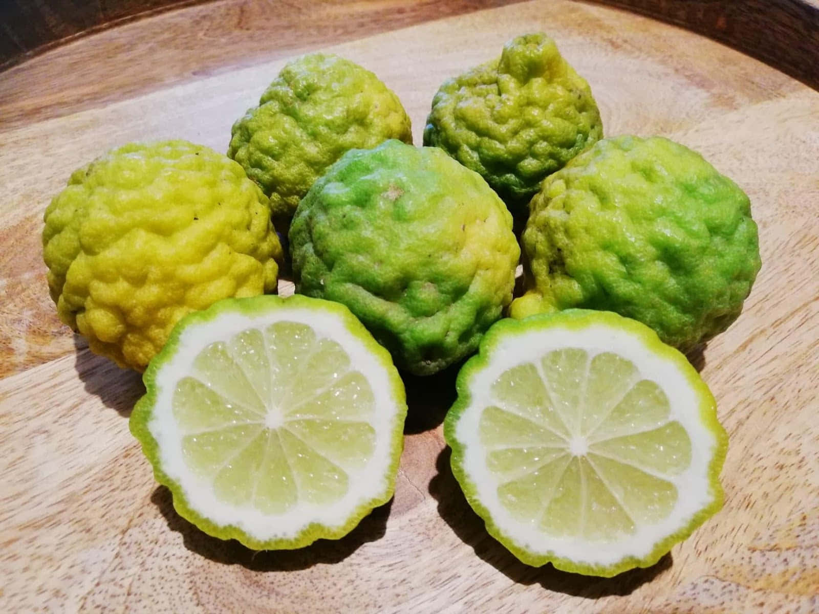 Sliced Kaffir Lime Fruits On Table Background