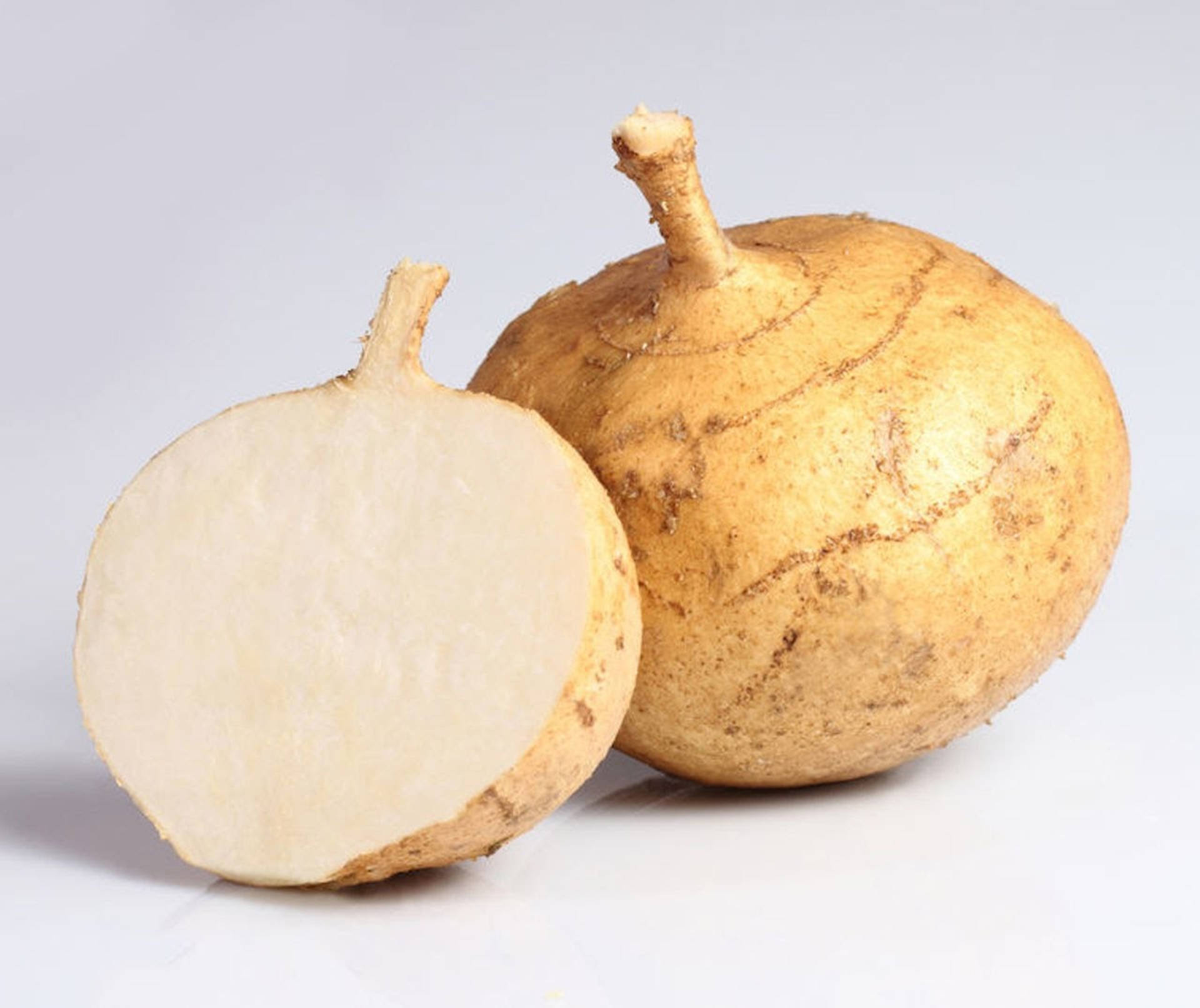 Sliced Open Jicama On A Wooden Cutting Board Background