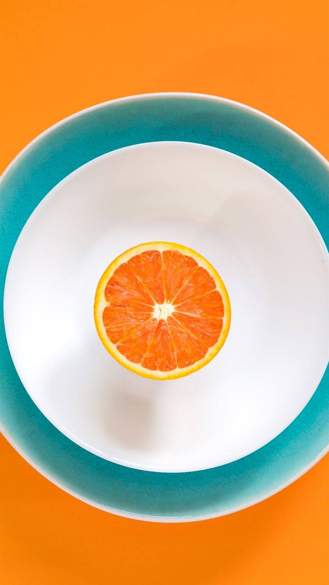 Sliced Orange Fruit On Plate Background