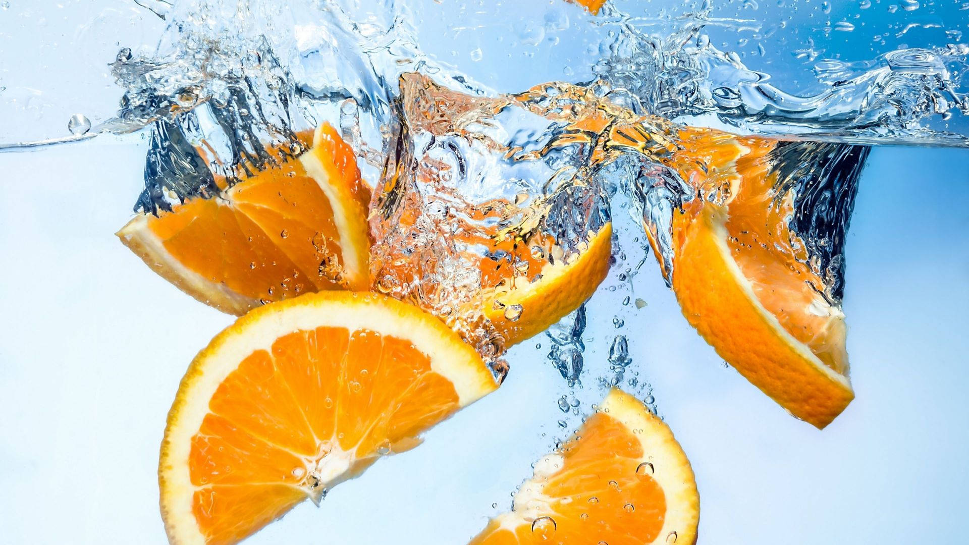 Sliced Orange Fruits Deep In Water Background