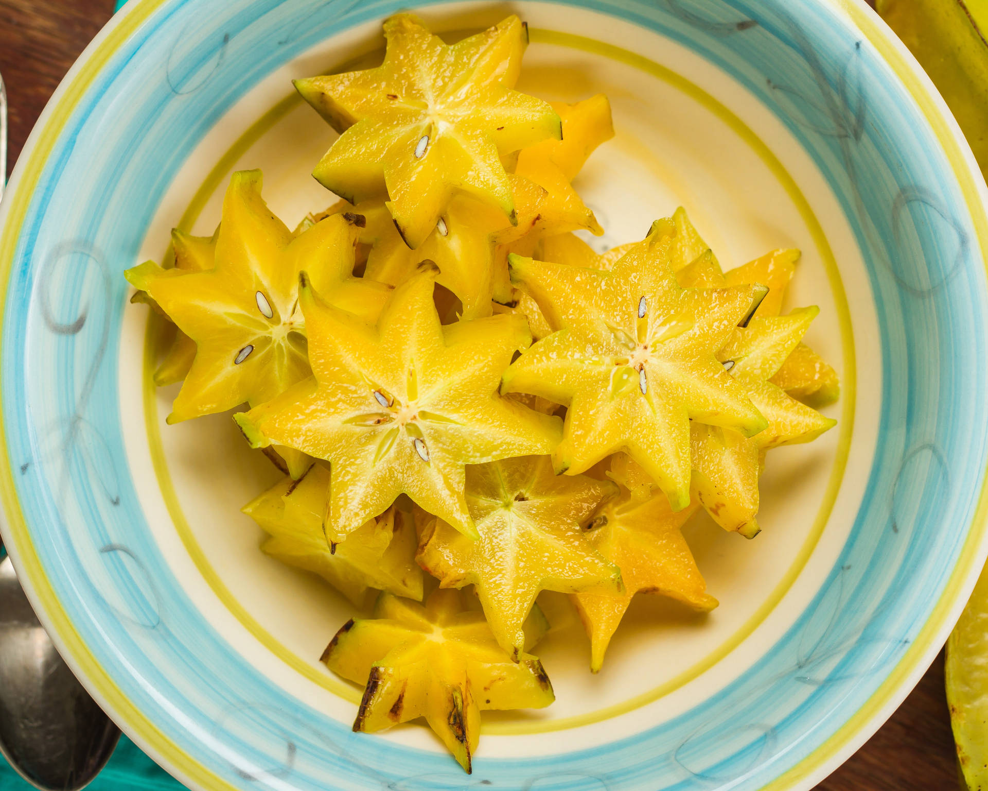 Slices Of Star Fruit In Bowl Background