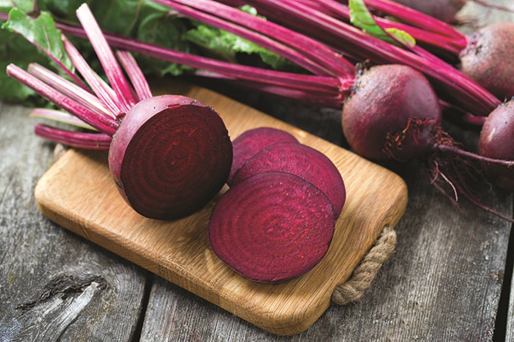 Slicing Fresh Purple Beetroot Background