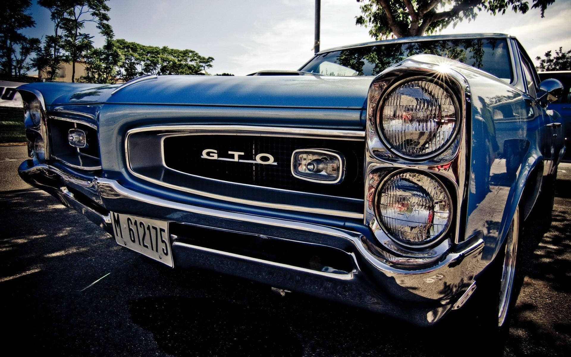 Slick Front Bumper Of A Classic Pontiac Gto Background