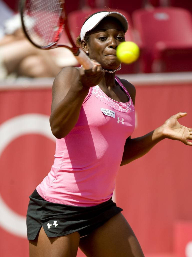 Sloane Stephens Hitting A Tennis Ball Background