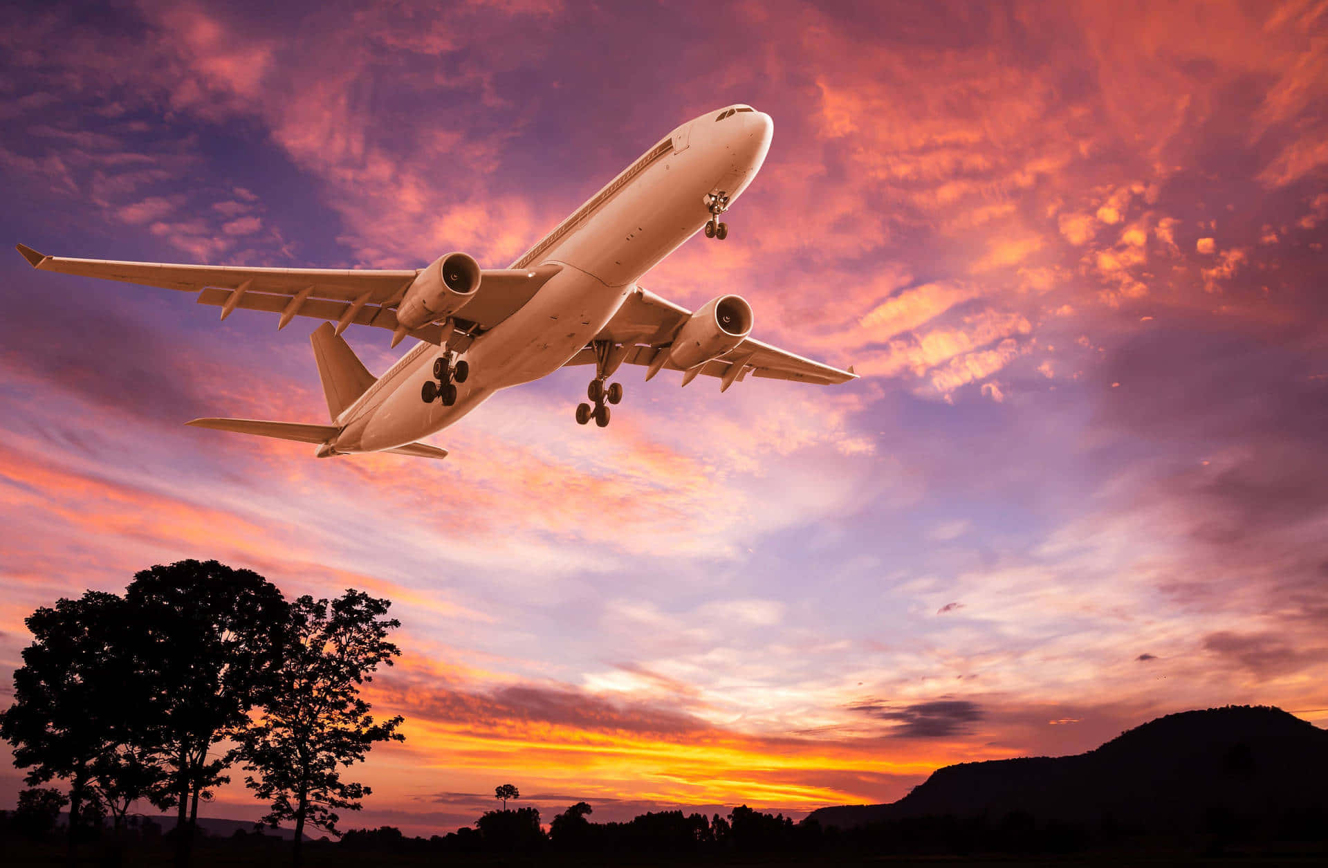 Small Airplane Gliding Over Sunset Landscape Background