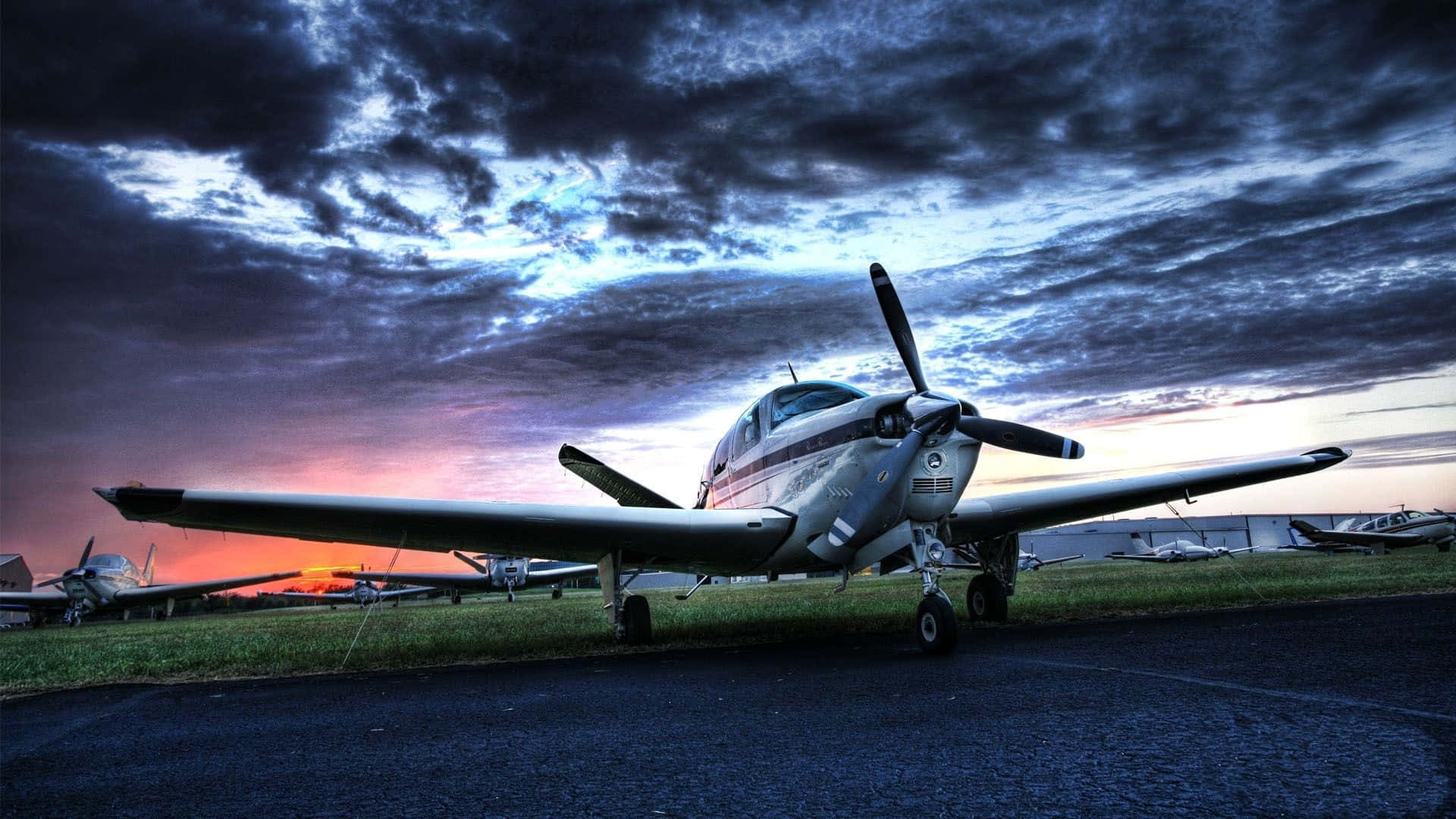 Small Airplane On Runway With Other Aircrafts