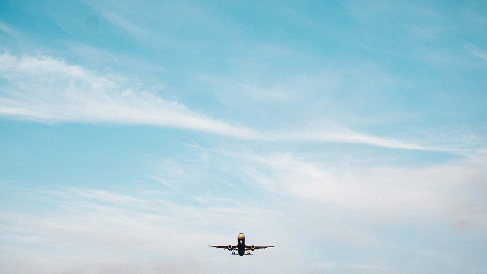 Small Airplane Soaring At The Blue Sky Background