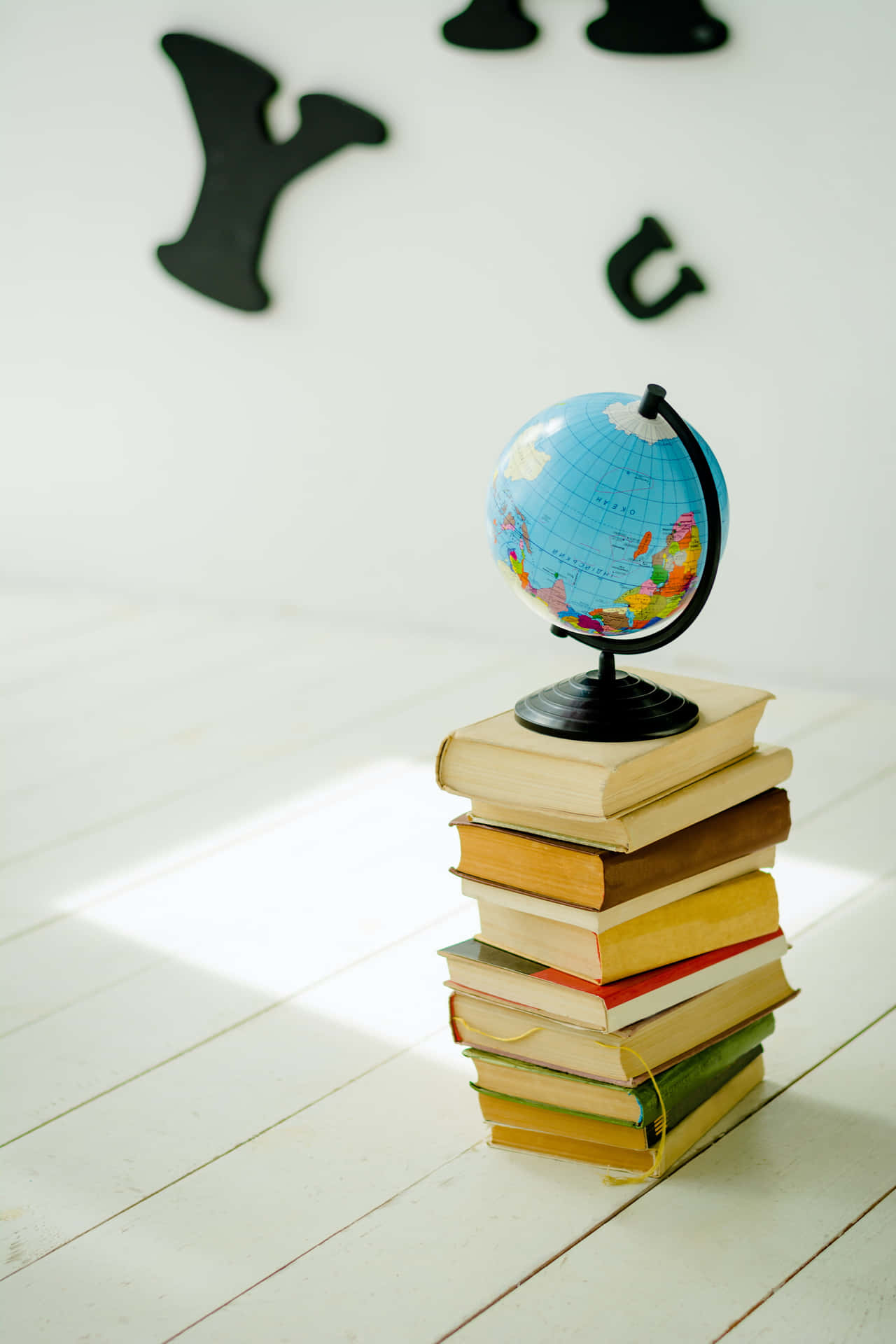 Small Globe Map On Stacked Books Background