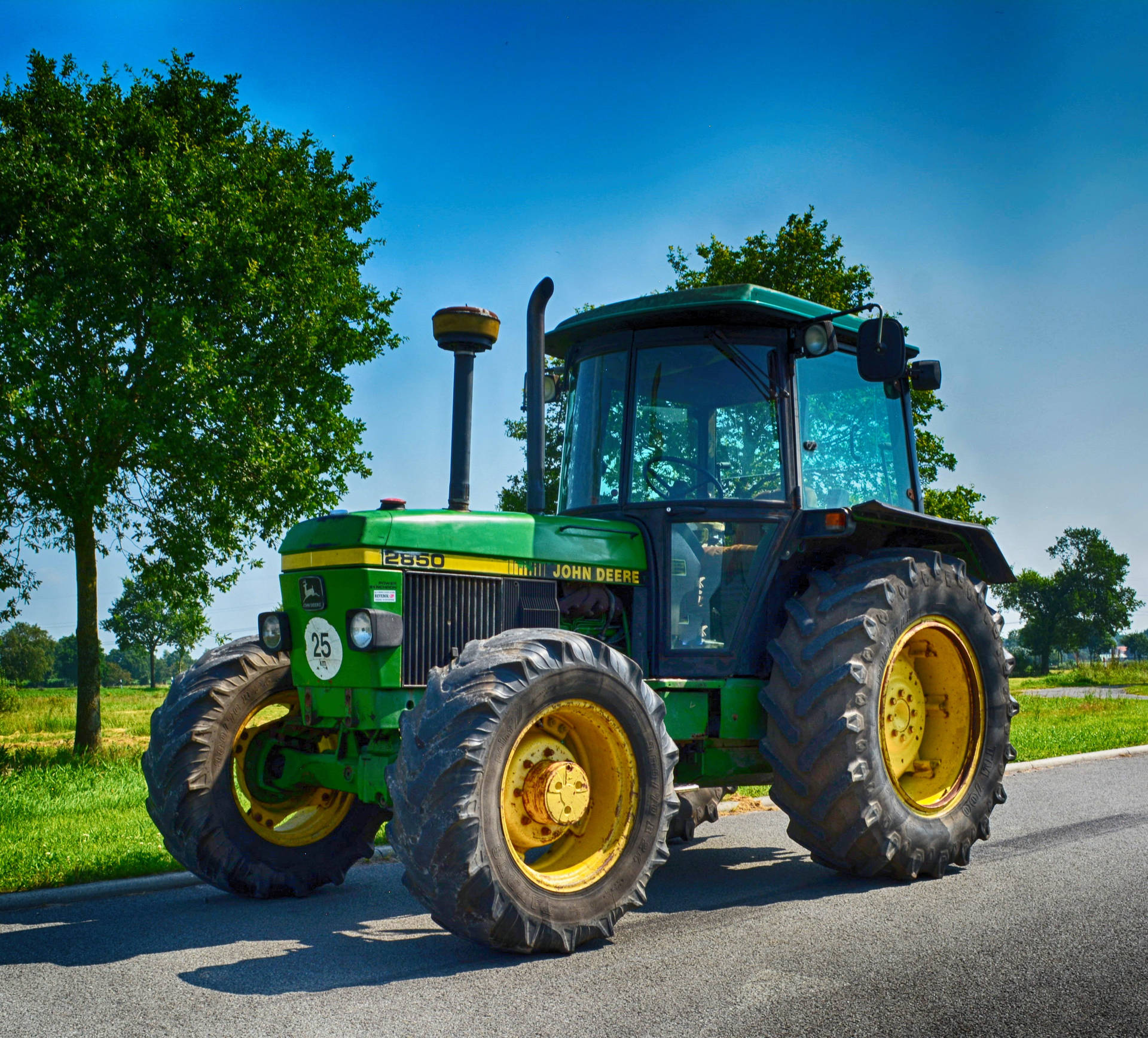 Small John Deere Tractor On Road Background