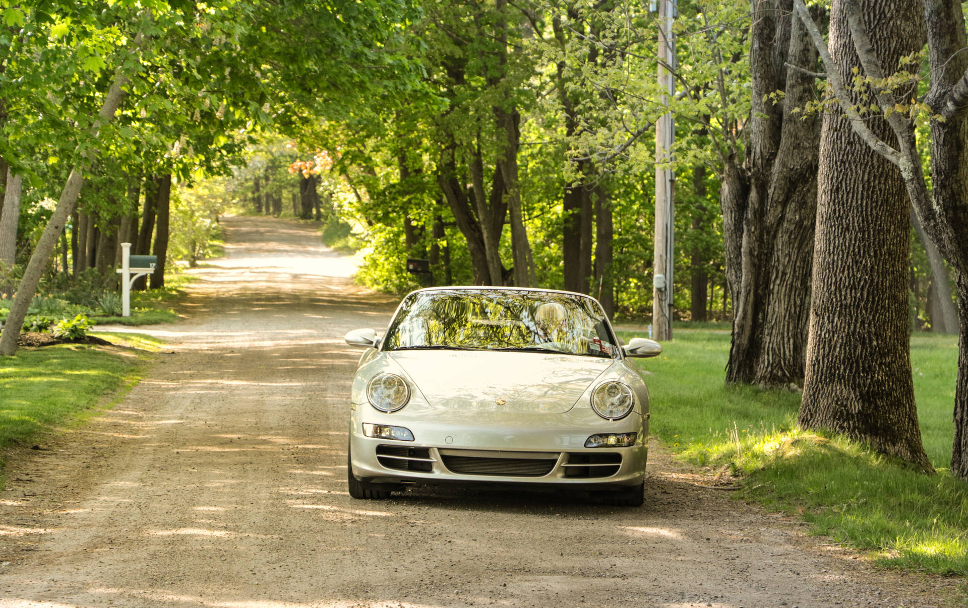 Small Luxury Car On Country Road Background