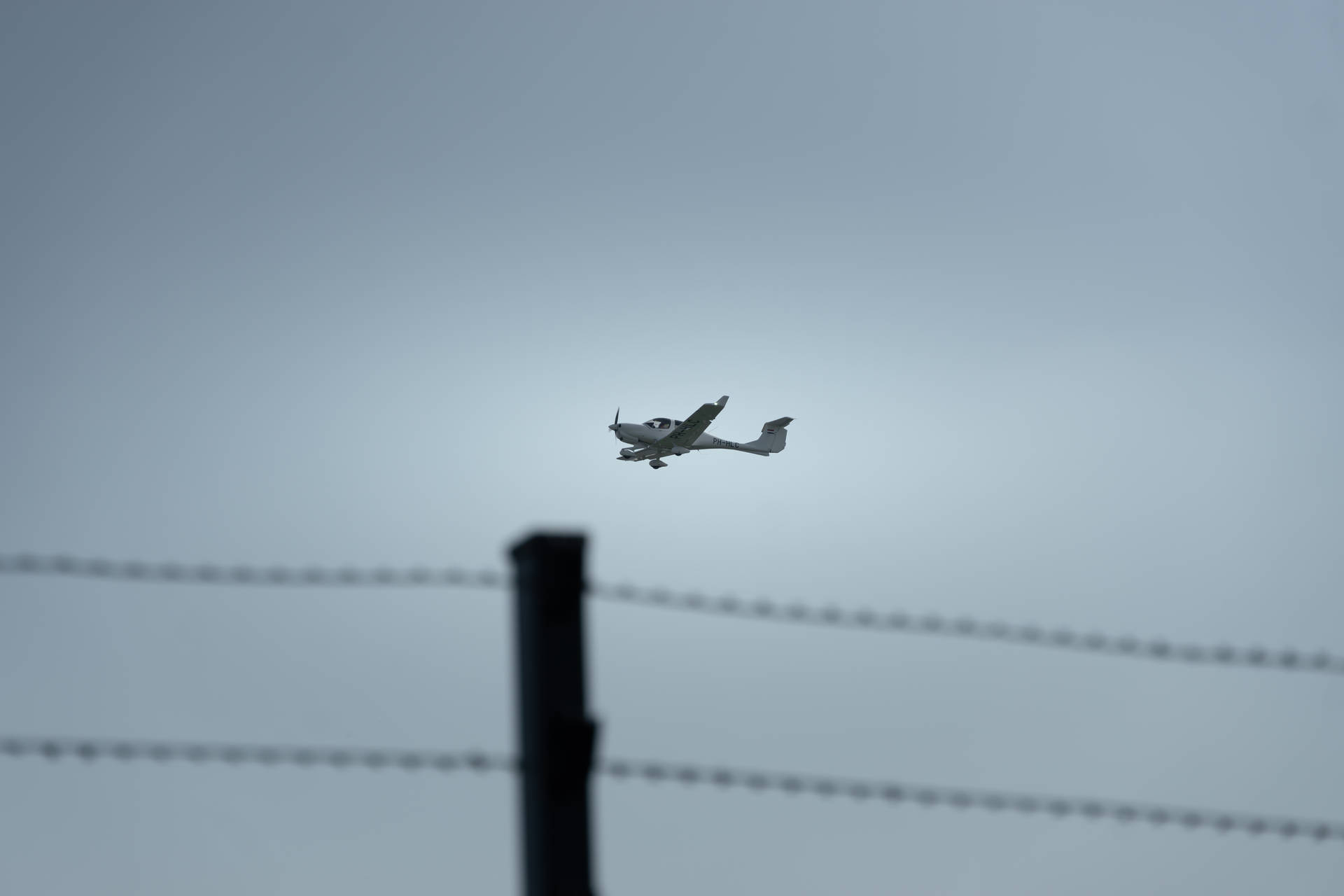 Small Plane In Gray Sky Background