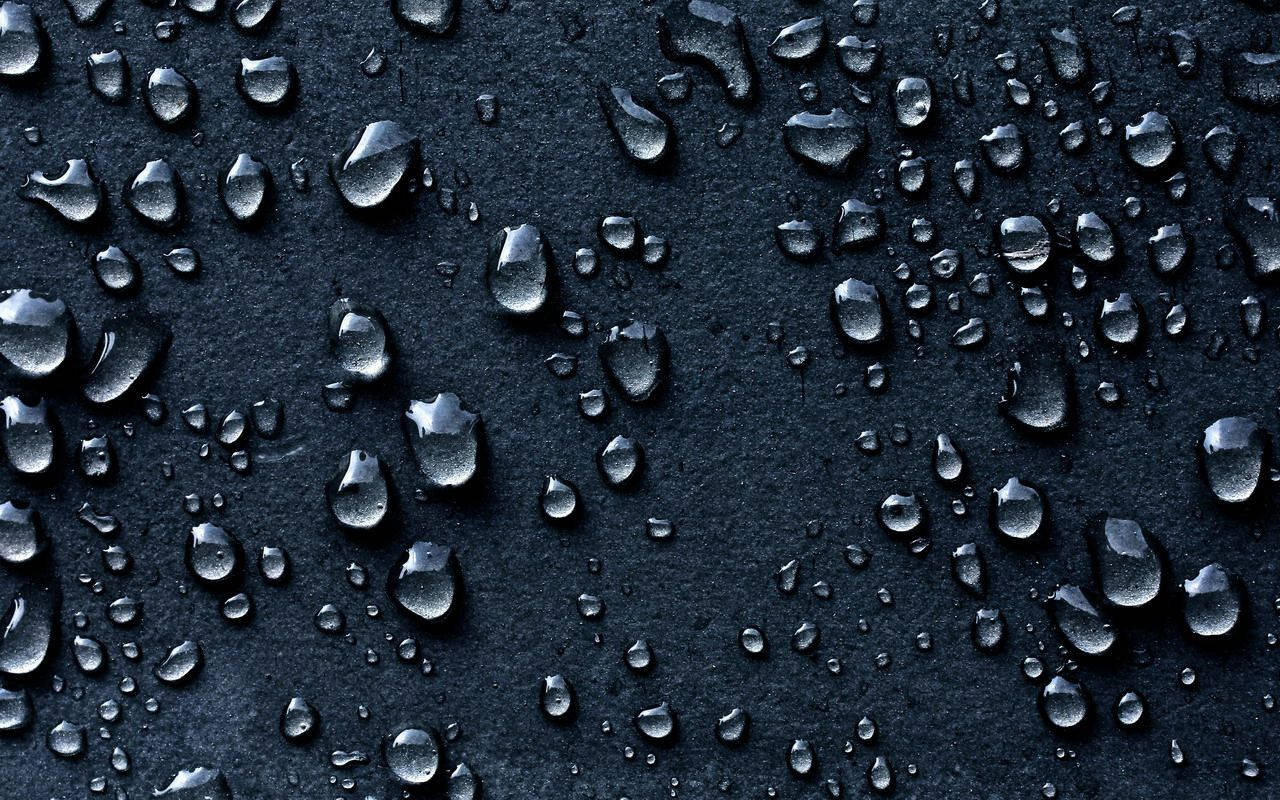 Small Raindrops On Black Surface Background