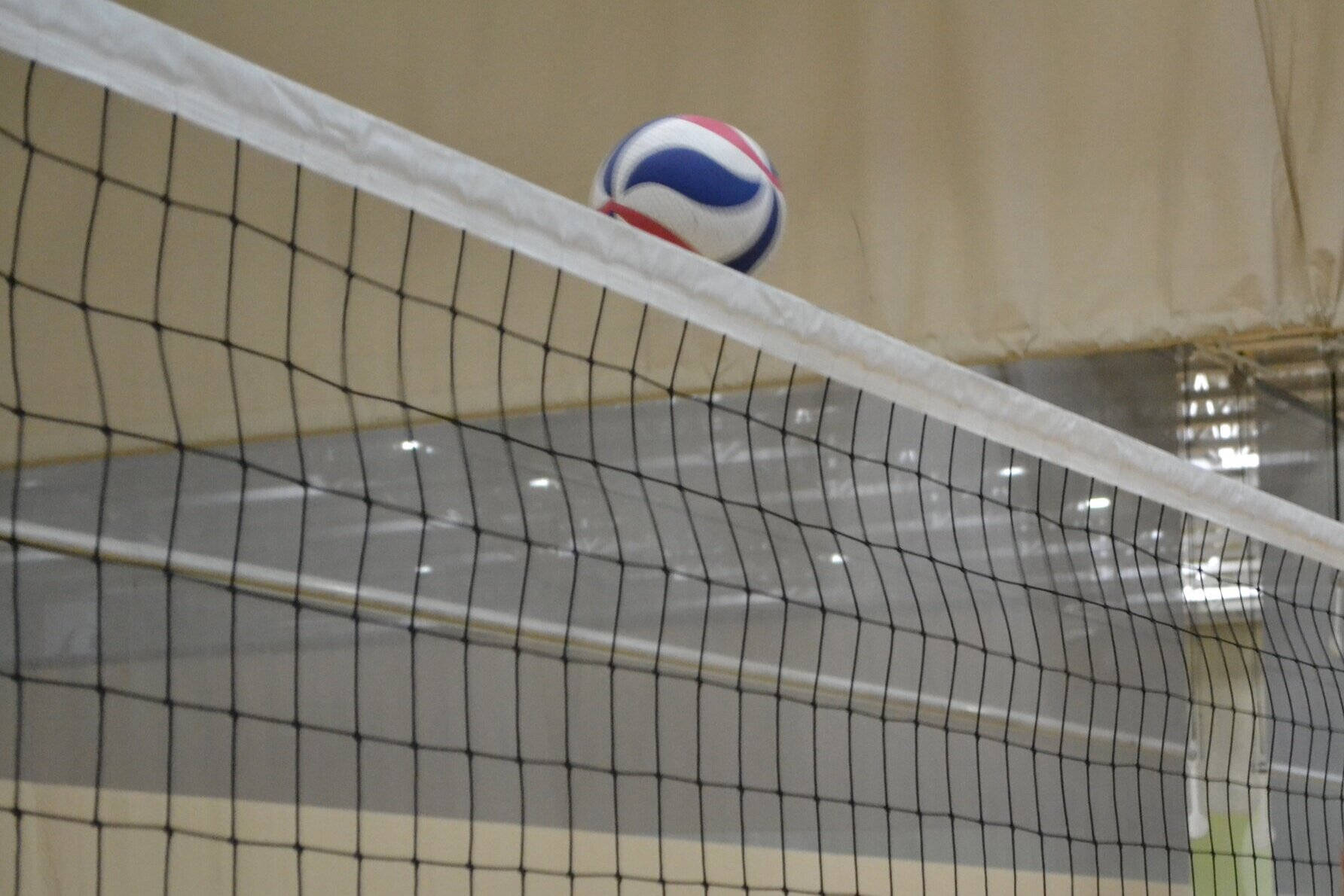 Smashing Victory In An Intense Game Of Indoor Volleyball Background