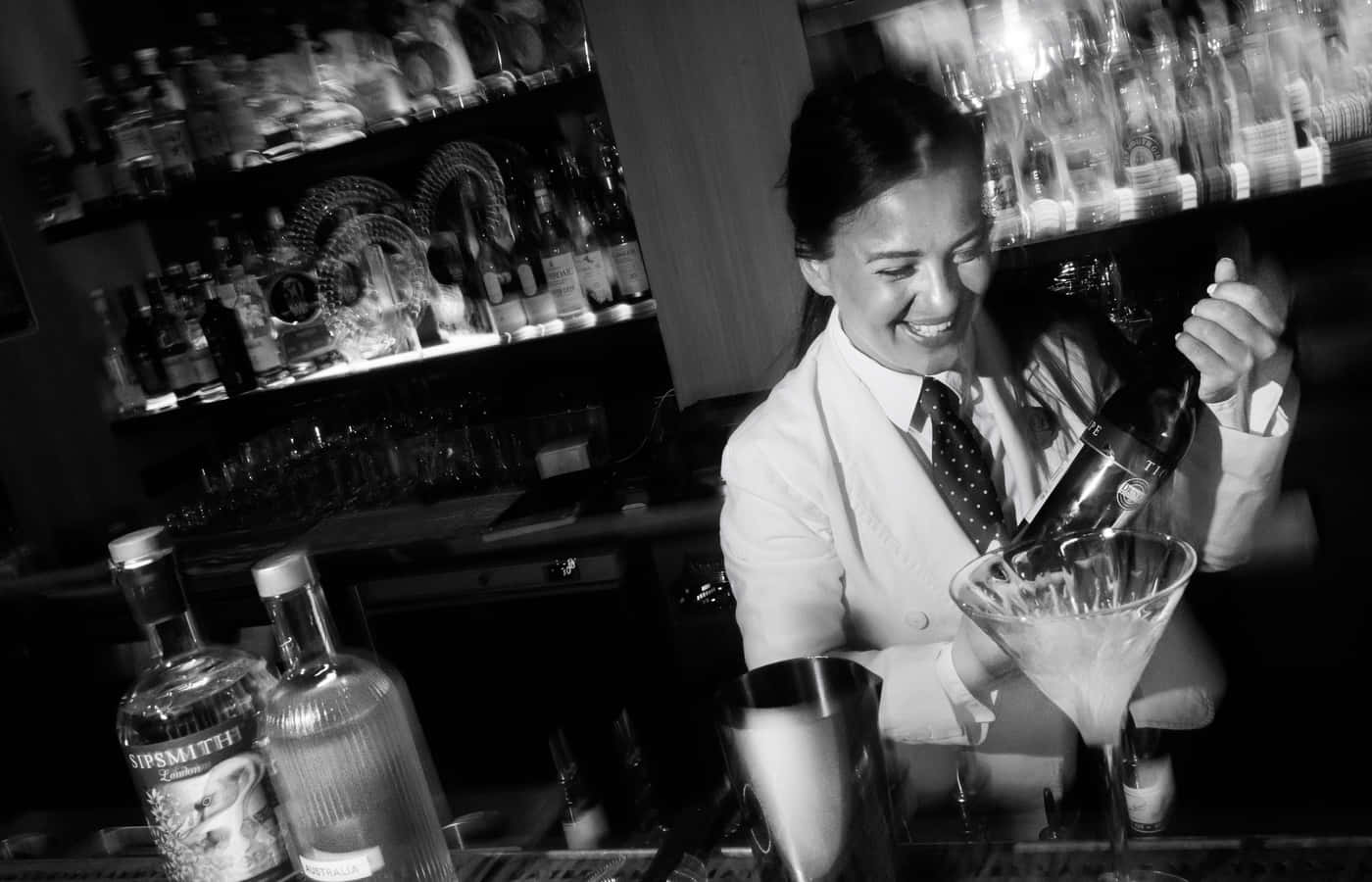 Smiling Bartender Pouring Cocktail Background