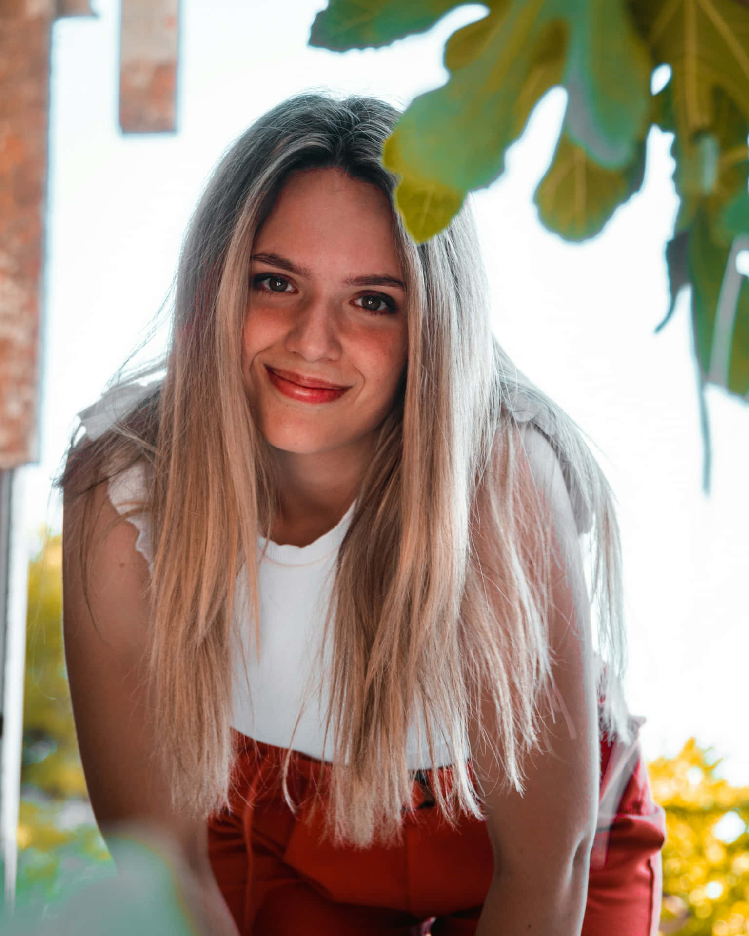 Smiling Blonde Womanin Red Overalls Background