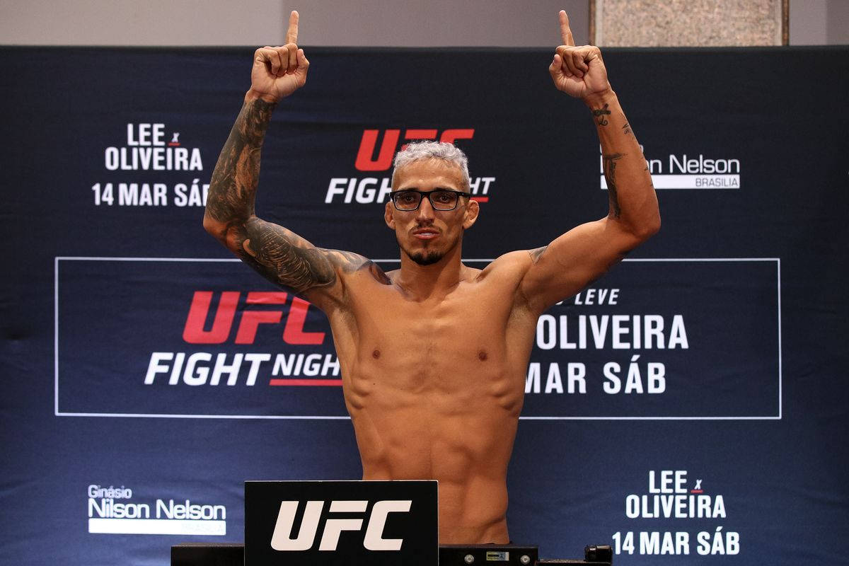 Smiling Charles Oliveira Wearing Glasses Background