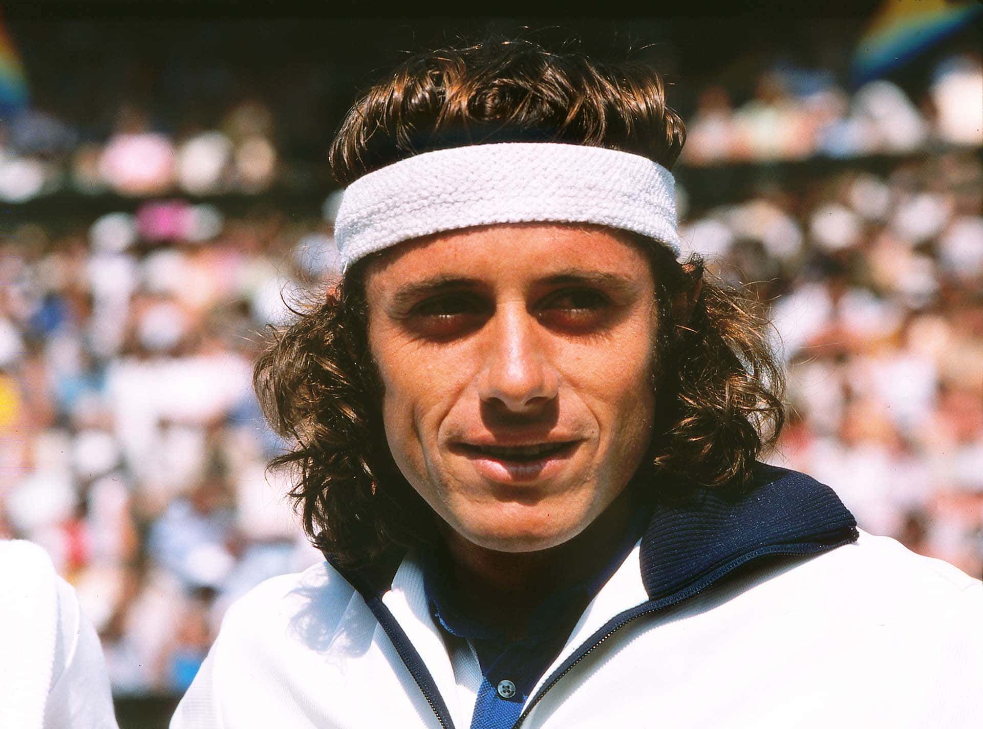 Smiling Closeup Front Profile Guillermo Vilas Background